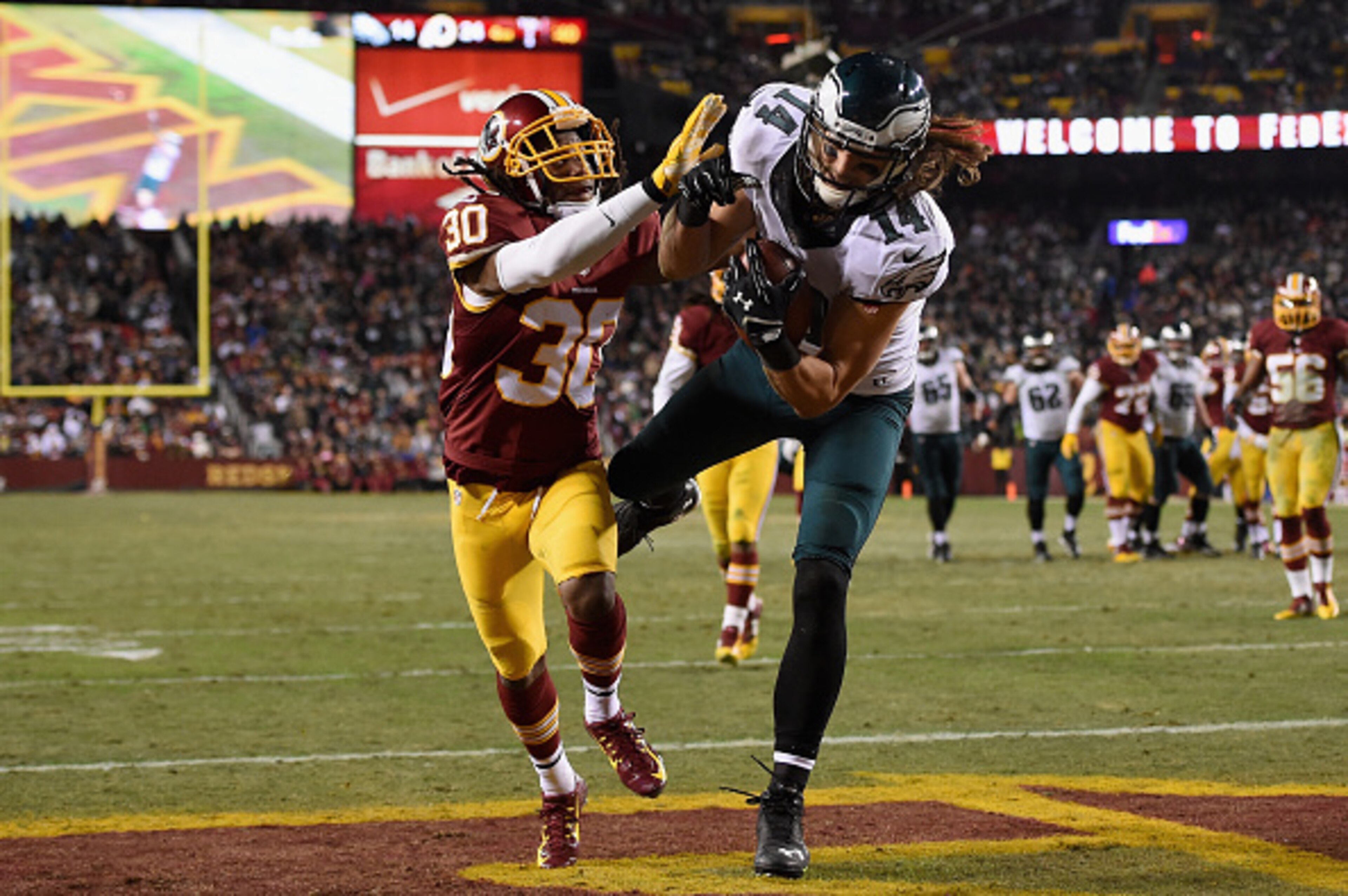 LANDOVER, MD - DECEMBER 20:  Wide receiver Riley Cooper #14 of the Philadelphia Eagles makes a fourth quarter touchdown catch over the defense of free safety E.J. Biggers #30 of the Washington Redskins at FedExField on December 20, 2014 in Landover, Maryl