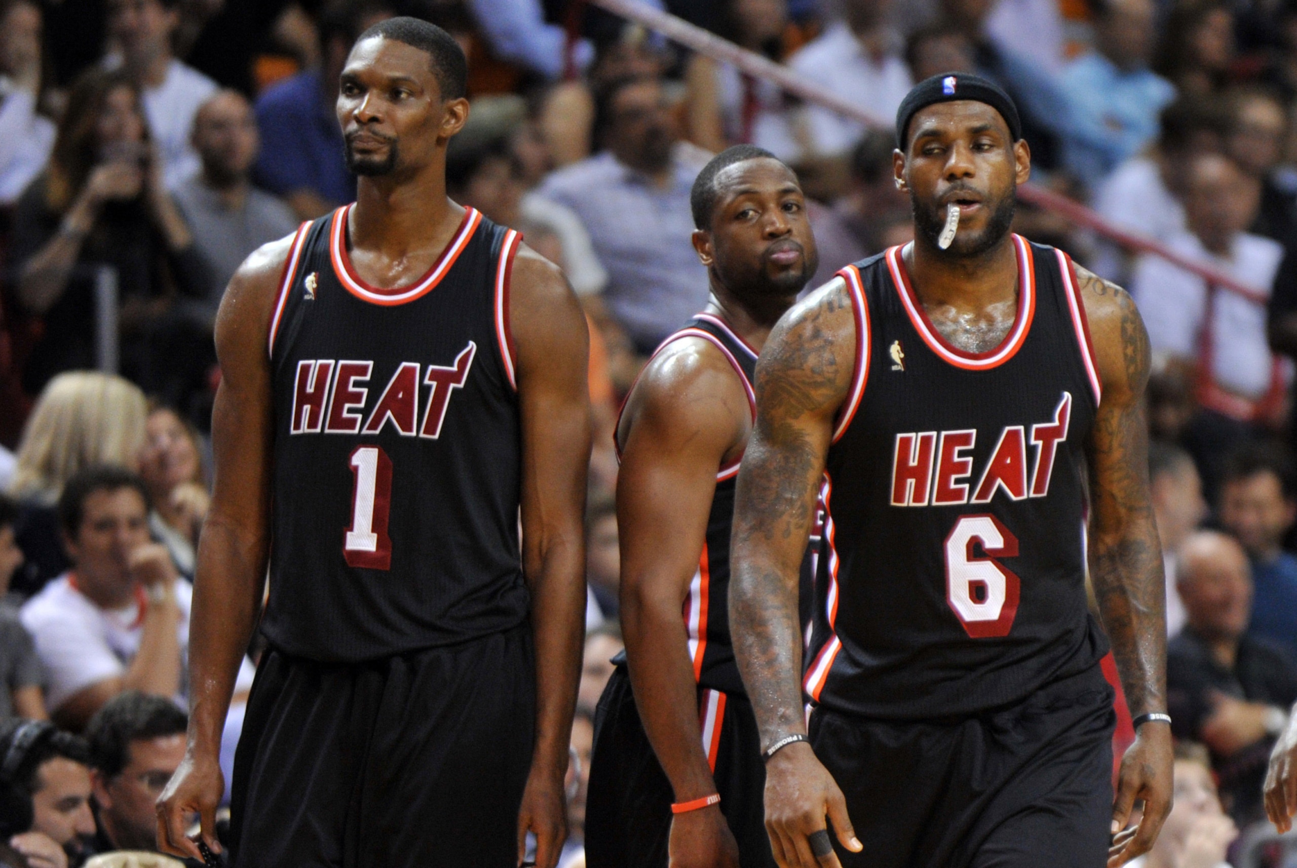 Jan 29, 2014; Miami, FL, USA; Miami Heat center Chris Bosh (left) shooting guard Dwyane Wade (center) and small forward LeBron James (right) react after a timeout after the Oklahoma City Thunder during the second half at American Airlines Arena. Mandatory