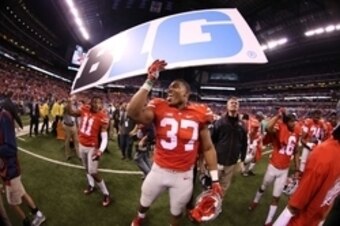 Dec 6, 2014; Indianapolis, IN, USA; Ohio State Buckeyes safety Vonn Bell (11) and linebacker Joshua Perry (37) hold up a Big 10 sign after defeating the Wisconsin Badgers in the Big Ten Football Championship game at Lucas Oil Stadium. Ohio State defeats W