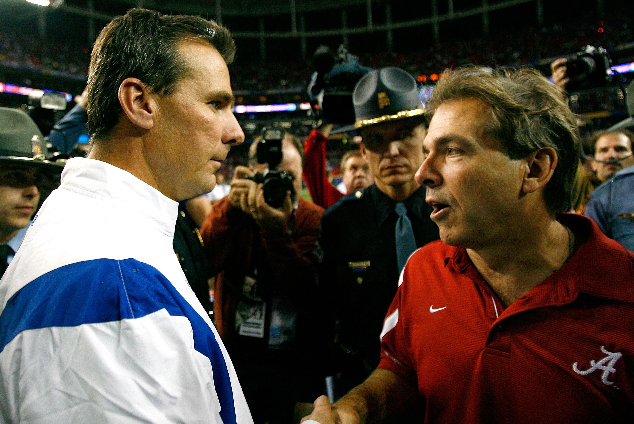 ATLANTA - DECEMBER 06:  Head coach Nick Saban of the Alabama Crimson Tide congratulates head coach Urban Meyer of the Florida Gators after the Gators 31-20 win in the SEC Championship on December 6, 2008 at the Georgia Dome in Atlanta, Georgia.  (Photo by