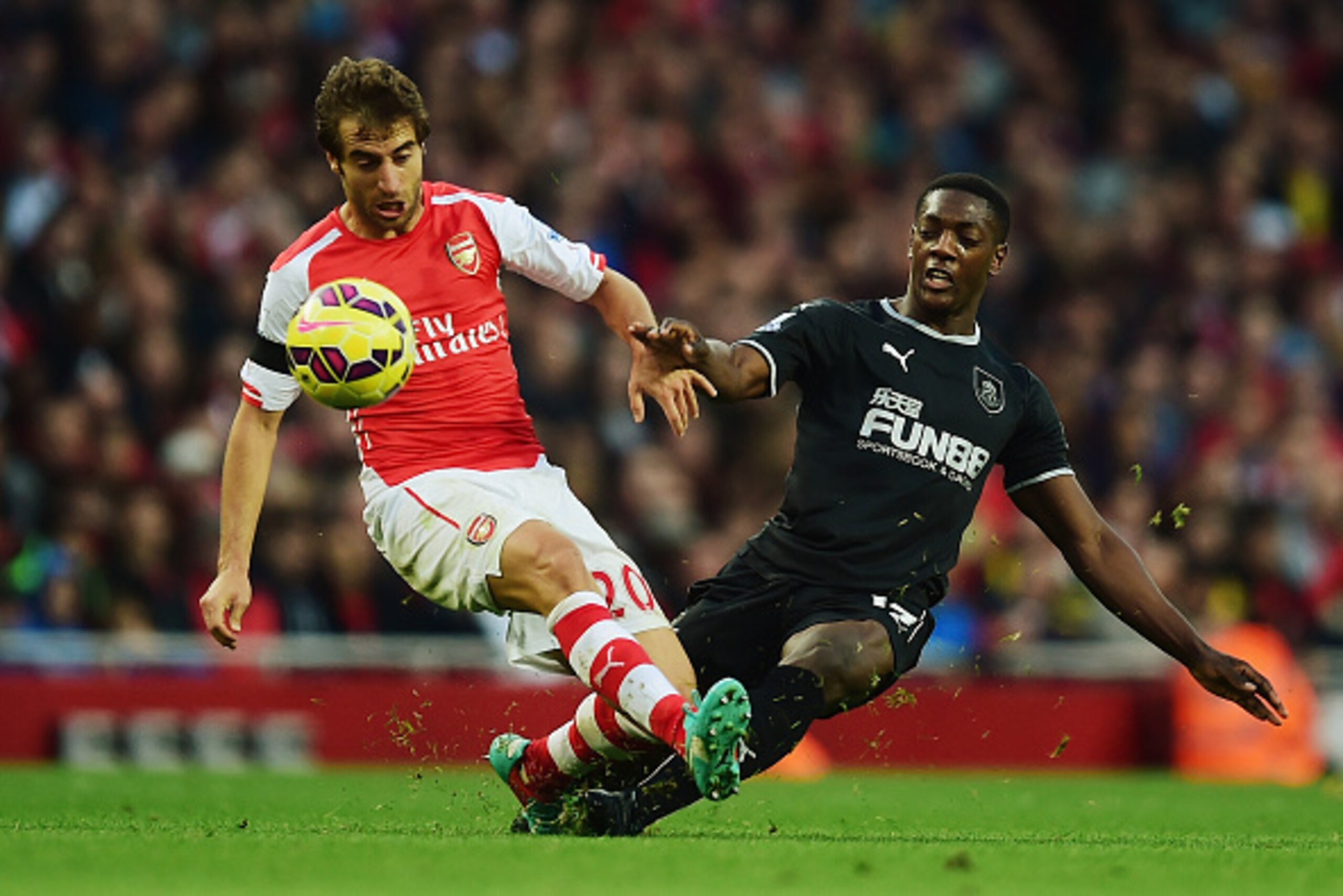 LONDON, ENGLAND - NOVEMBER 01: Mathieu Flamini of Arsenal is tackeld by Marvin Sordell of Burnley during the Barclays Premier League match between Arsenal and Burnley at Emirates Stadium on November 1, 2014 in London, England. (Photo by Jamie McDonald/ LONDON, ENGLAND - NOVEMBER 01: Mathieu Flamini of Arsenal is tackeld by Marvin Sordell of Burnley during the Barclays Premier League match between Arsenal and Burnley at Emirates Stadium on November 1, 2014 in London, England. (Photo by Jamie McDonald/
