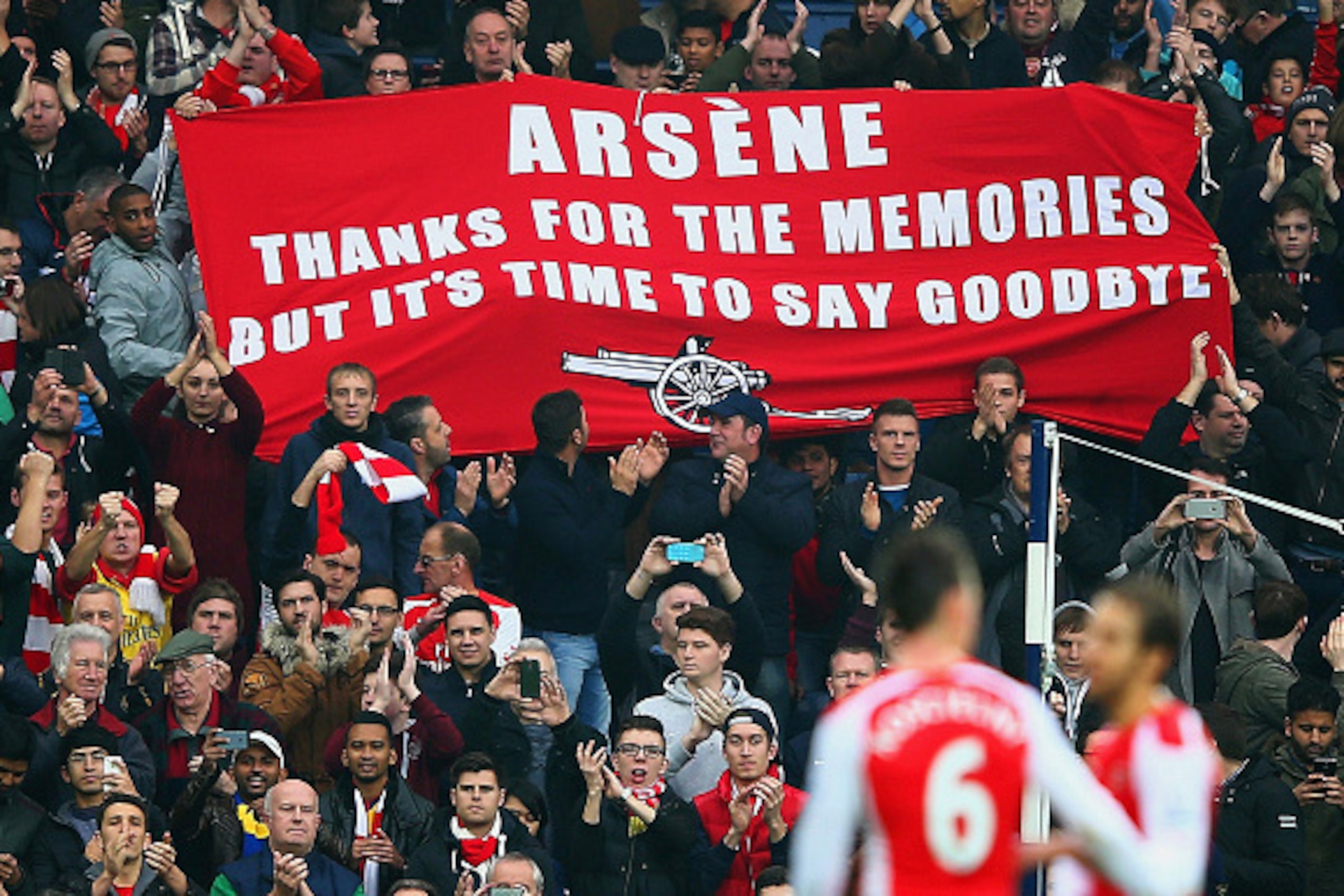 WEST BROMWICH, ENGLAND - NOVEMBER 29: (EDITORS NOTE: This is a retransmission of image #459708260 with an alternative crop) Arsenal fans hold up a banner for Arsene Wenger, manager of Arsenal during the Barclays Premier League match between West Bromw WEST BROMWICH, ENGLAND - NOVEMBER 29: (EDITORS NOTE: This is a retransmission of image #459708260 with an alternative crop) Arsenal fans hold up a banner for Arsene Wenger, manager of Arsenal during the Barclays Premier League match between West Bromw