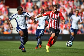 SOUTHAMPTON, ENGLAND - AUGUST 23:  Morgan Schneiderlin of Southampton holds off a challenge from Andre Wisdom of West Brom during the Barclays Premier League match between Southampton and West Bromwich Albion at St Mary's Stadium on August 23, 2014 in Sou