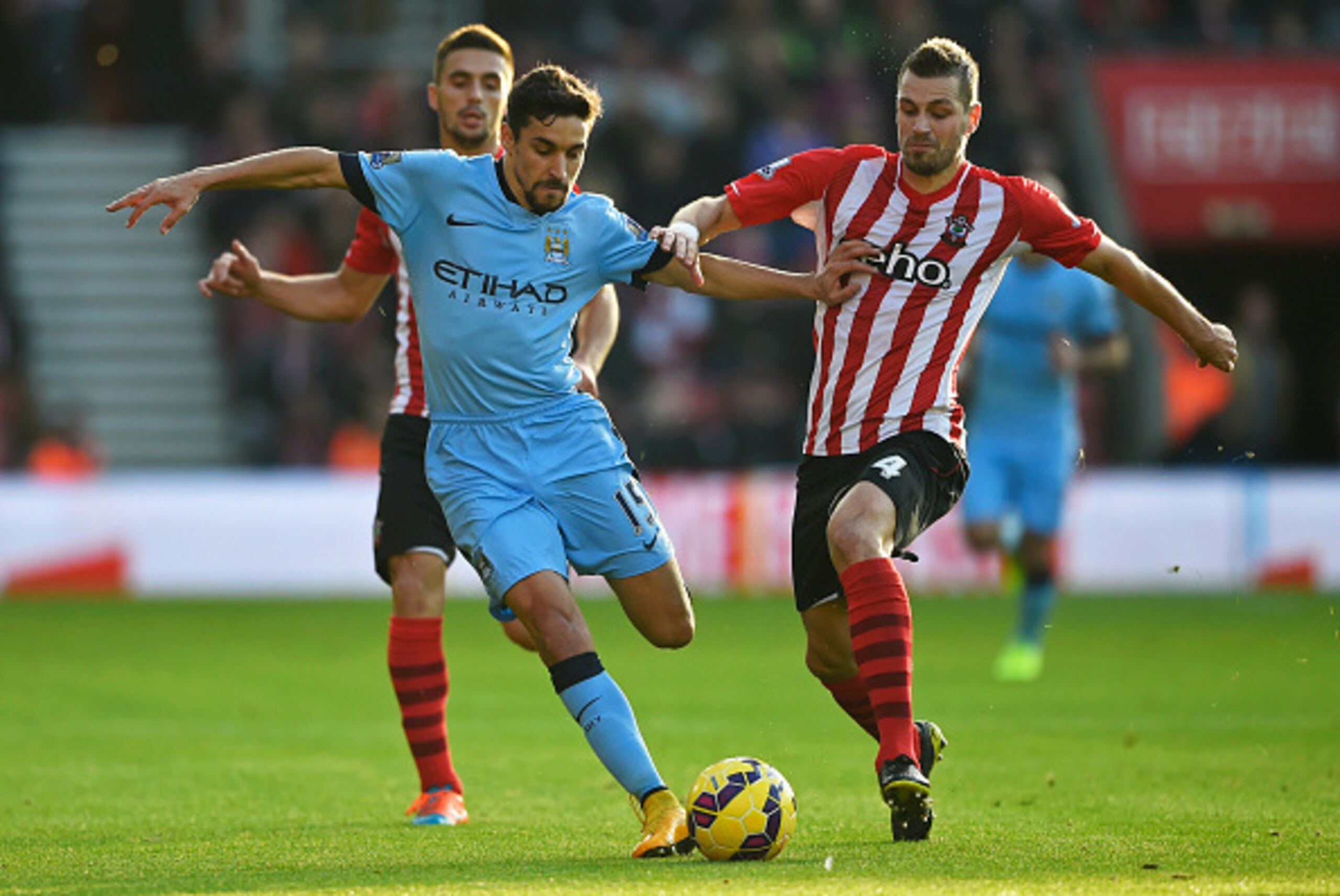 SOUTHAMPTON, ENGLAND - NOVEMBER 30: Jesus Navas of Manchester City holds off Morgan Schneiderlin of Southampton during the Barclays Premier League match between Southampton and Manchester City at St Mary's Stadium on November 30, 2014 in Southampton, Eng SOUTHAMPTON, ENGLAND - NOVEMBER 30: Jesus Navas of Manchester City holds off Morgan Schneiderlin of Southampton during the Barclays Premier League match between Southampton and Manchester City at St Mary's Stadium on November 30, 2014 in Southampton, Eng