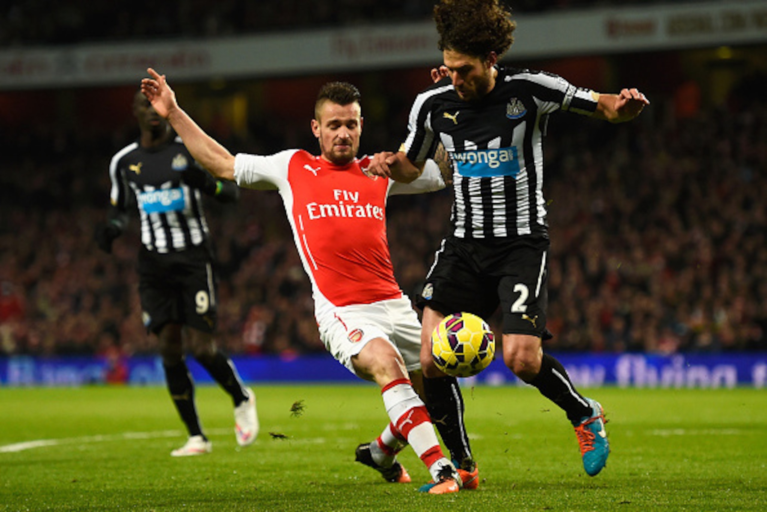 LONDON, ENGLAND - DECEMBER 13: Mathieu Debuchy of Arsenal tackles Fabricio Coloccini of Newcastle United during the Barclays Premier League match between Arsenal and Newcastle United at Emirates Stadium on December 13, 2014 in London, England. (Photo by LONDON, ENGLAND - DECEMBER 13: Mathieu Debuchy of Arsenal tackles Fabricio Coloccini of Newcastle United during the Barclays Premier League match between Arsenal and Newcastle United at Emirates Stadium on December 13, 2014 in London, England. (Photo by