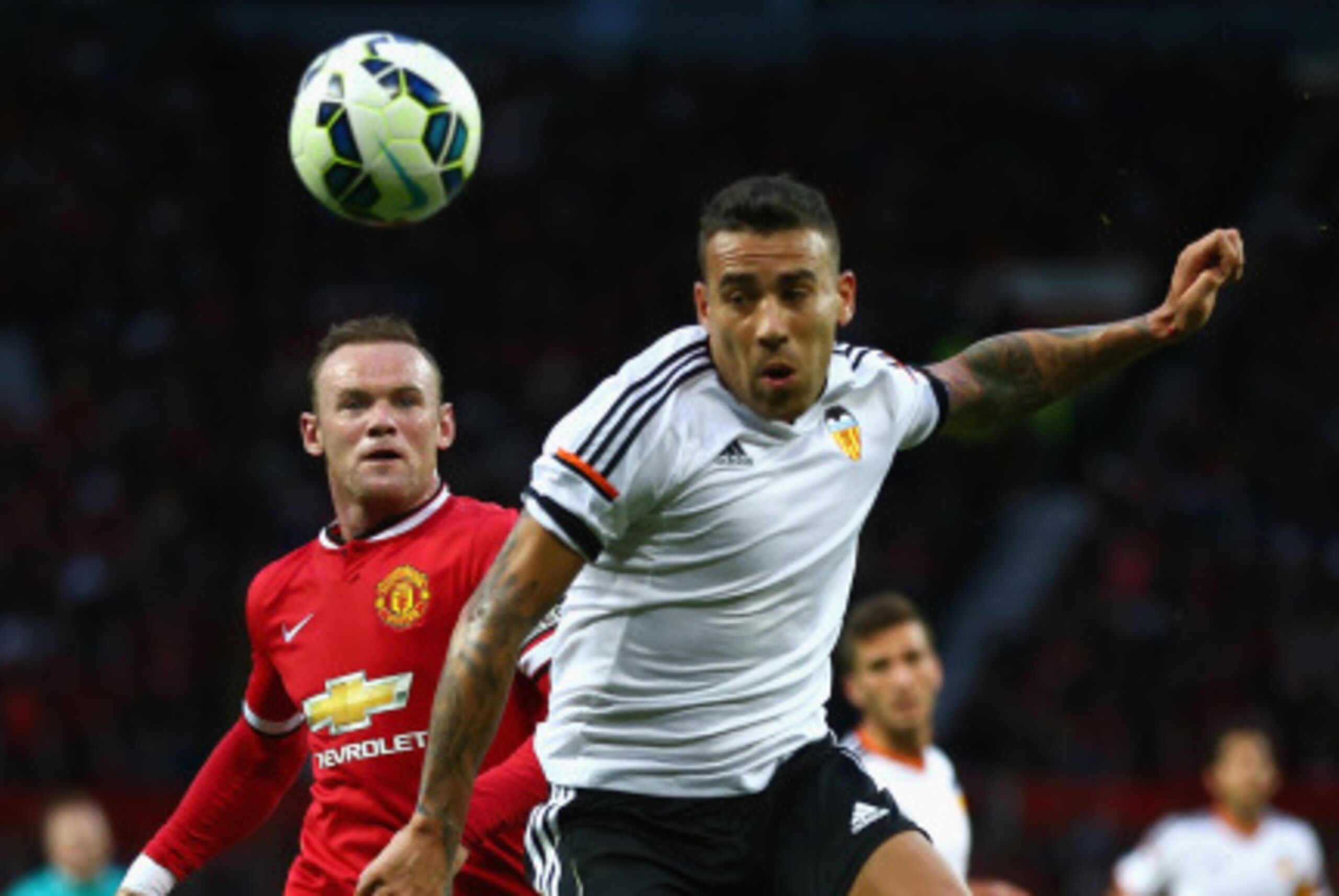 MANCHESTER, ENGLAND - AUGUST 12: Wayne Rooney of Manchester United in action with  Nicolas Otamendi of Valencia during the Pre Season Friendly match between Manchester United and Valencia at Old Trafford on August 12, 2014 in Manchester, England.  (Photo 