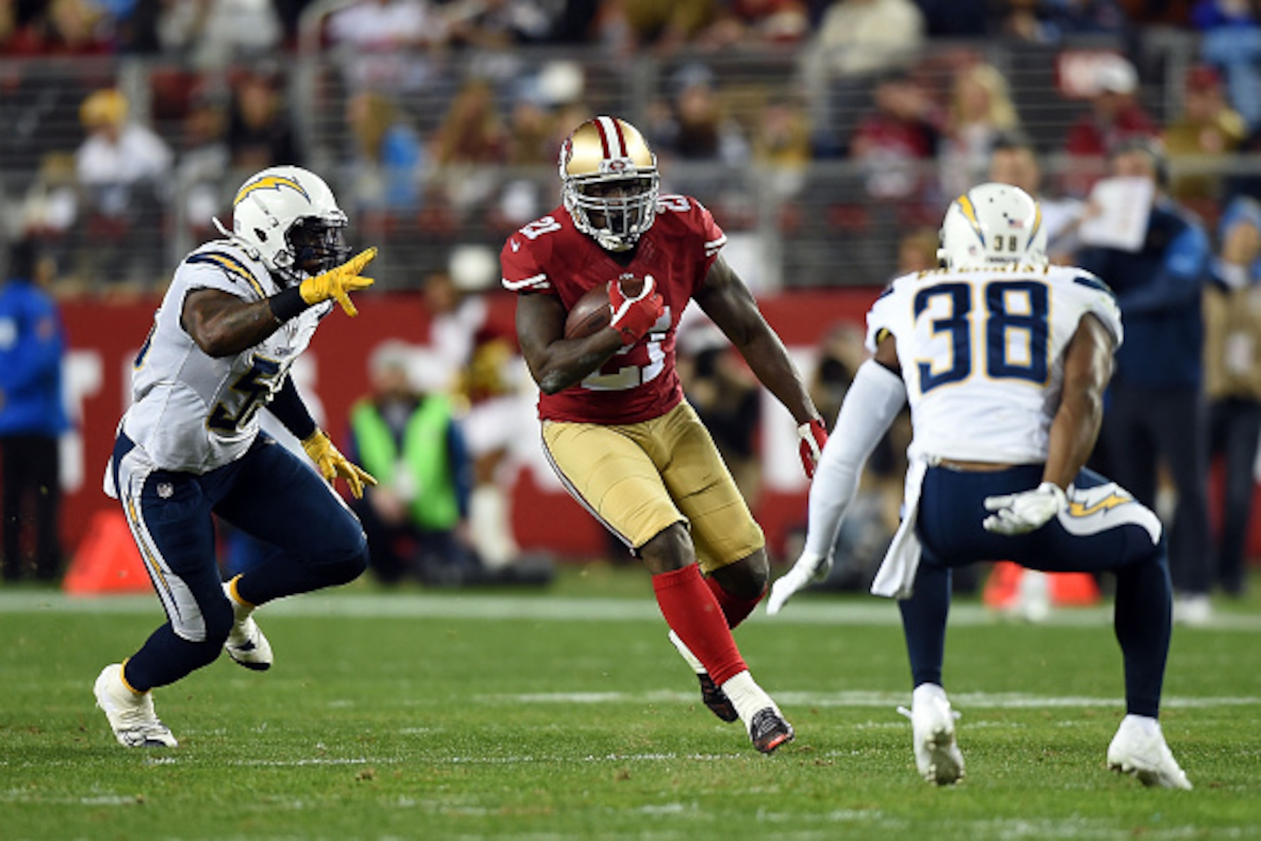 SANTA CLARA, CA - DECEMBER 20:  Frank Gore #21 of the San Francisco 49ers avoids the defense of Marcus Gilchrist #38  and Kavell Conner #53 of the San Diego Chargers at Levi's Stadium on December 20, 2014 in Santa Clara, California.  (Photo by Thearon W. 
