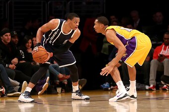 LOS ANGELES, CA - DECEMBER 19:  Russell Westbrook #0 of the Oklahoma City Thunder looks to drive against Wesley Johnson #11 of the Los Angeles Lakers at Staples Center on December 19, 2014 in Los Angeles, California. The Thunder won 104-103.  NOTE TO USER