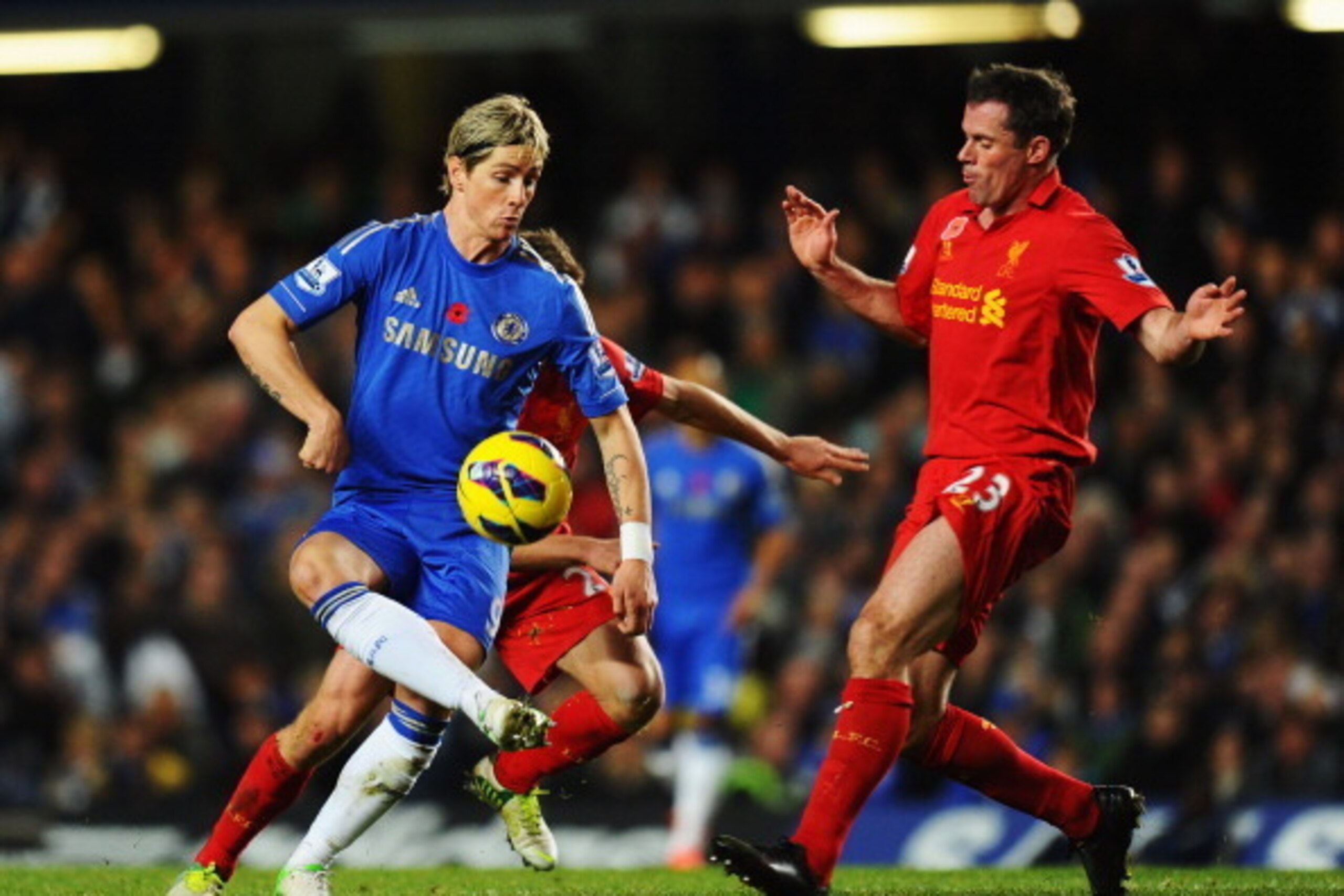 LONDON, ENGLAND - NOVEMBER 11:  Fernando Torres of Chelsea holds off the challenge of Jamie Carragher of Liverpool during the Barclays Premier League match between Chelsea and Liverpool at Stamford Bridge on November 11, 2012 in London, England.  (Photo b