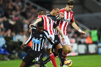 NEWCASTLE UPON TYNE, ENGLAND - DECEMBER 21:  Yoan Gouffran and Sammy Ameobi (L) of Newcastle United challenge for the ball with Sebastian Larsson (2ndL) and Sebastian Coates (R) of Sunderland during the Barclays Premier League match between Newcastle Unit