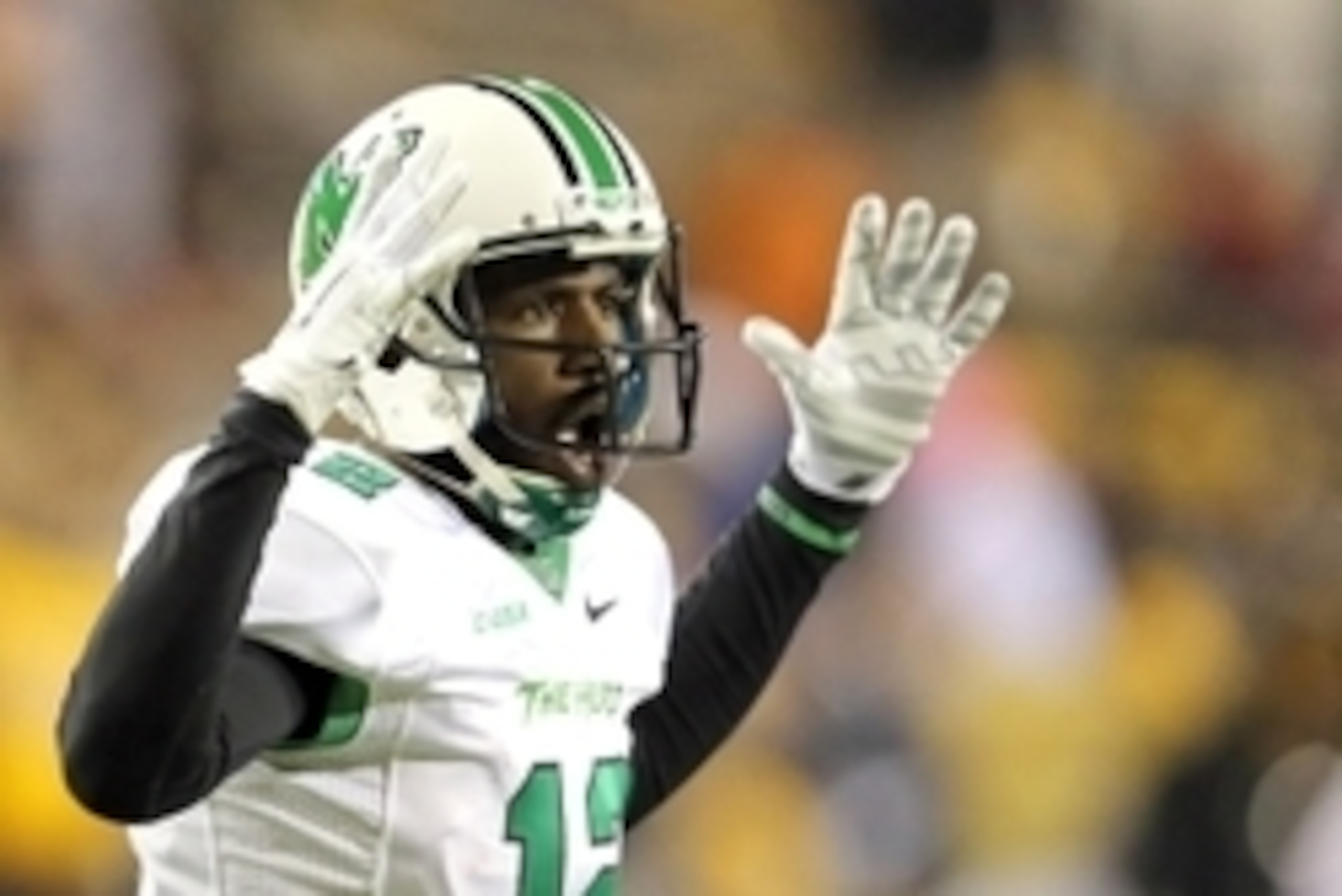 Nov 8, 2014; Hattiesburg, MS, USA; Marshall Thundering Herd quarterback Rakeem Cato (12) signals a touchdown in the fourth quarter of their game against the Southern Miss Golden Eagles at M.M. Roberts Stadium. Marshall won, 63-17. Mandatory Credit: Chuck 