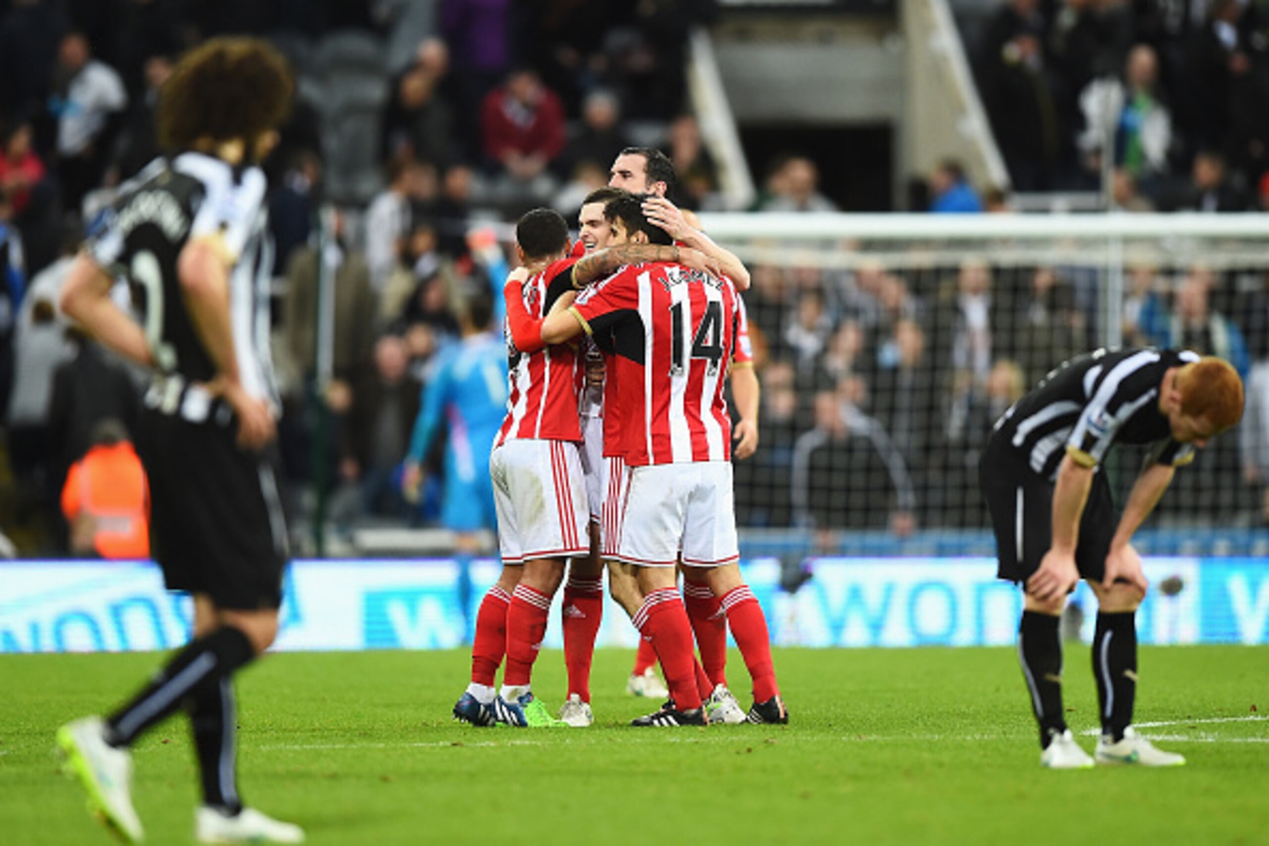 NEWCASTLE UPON TYNE, ENGLAND - DECEMBER 21:  Sunderland players mob Adam Johnson of Sunderland as they celebrate victory after the Barclays Premier League match between Newcastle United and Sunderland at St James' Park on December 21, 2014 in Newcastle up
