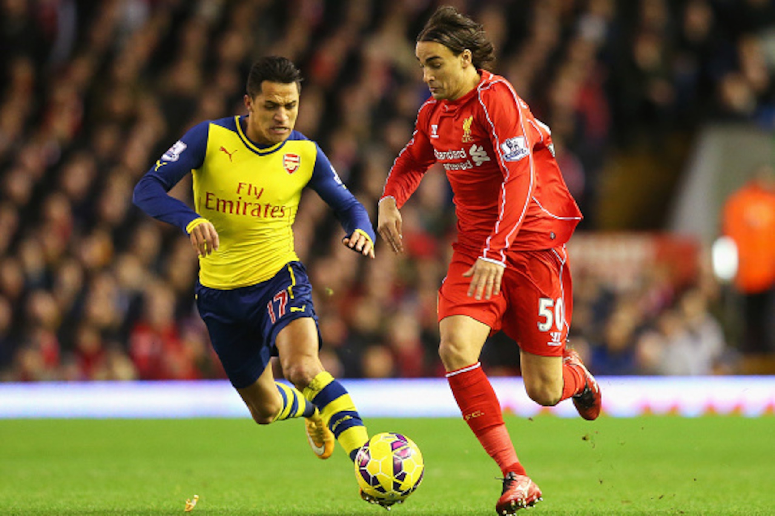 LIVERPOOL, ENGLAND - DECEMBER 21: Lazar Markovic of Liverpool is closed down by Alexis Sanchez of Arsenal during the Barclays Premier League match between Liverpool and Arsenal at Anfield on December 21, 2014 in Liverpool, England.  (Photo by Alex Livesey