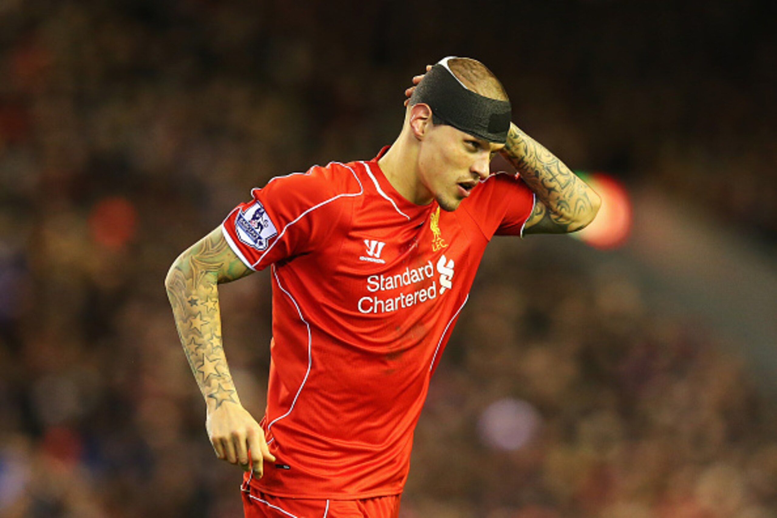 LIVERPOOL, ENGLAND - DECEMBER 21:  Martin Skrtel of Liverpool looks on with his head bandaged during the Barclays Premier League match between Liverpool and Arsenal at Anfield on December 21, 2014 in Liverpool, England.  (Photo by Alex Livesey/Getty Image