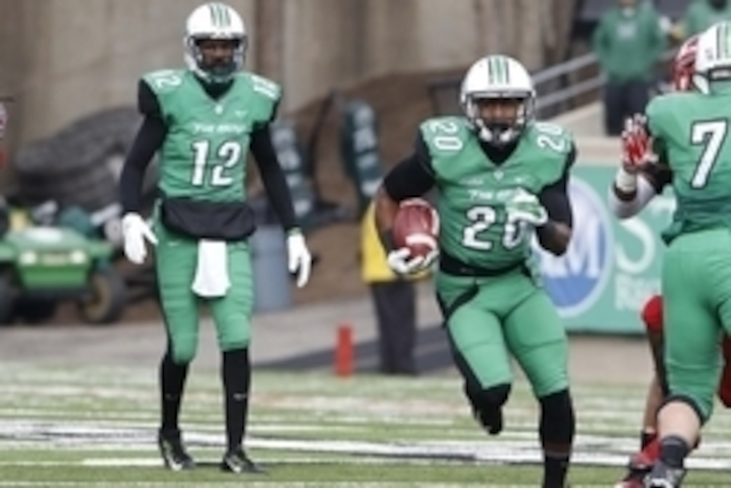 Nov 28, 2014; Huntington, WV, USA; Marshall Thundering Herd running back Steward Butler (20) runs the ball in front of quarterback Rakeem Cato (12) during the game against the Western Kentucky Hiltoppers during the first half at Joan C. Edwards Stadium. M Nov 28, 2014; Huntington, WV, USA; Marshall Thundering Herd running back Steward Butler (20) runs the ball in front of quarterback Rakeem Cato (12) during the game against the Western Kentucky Hiltoppers during the first half at Joan C. Edwards Stadium. M