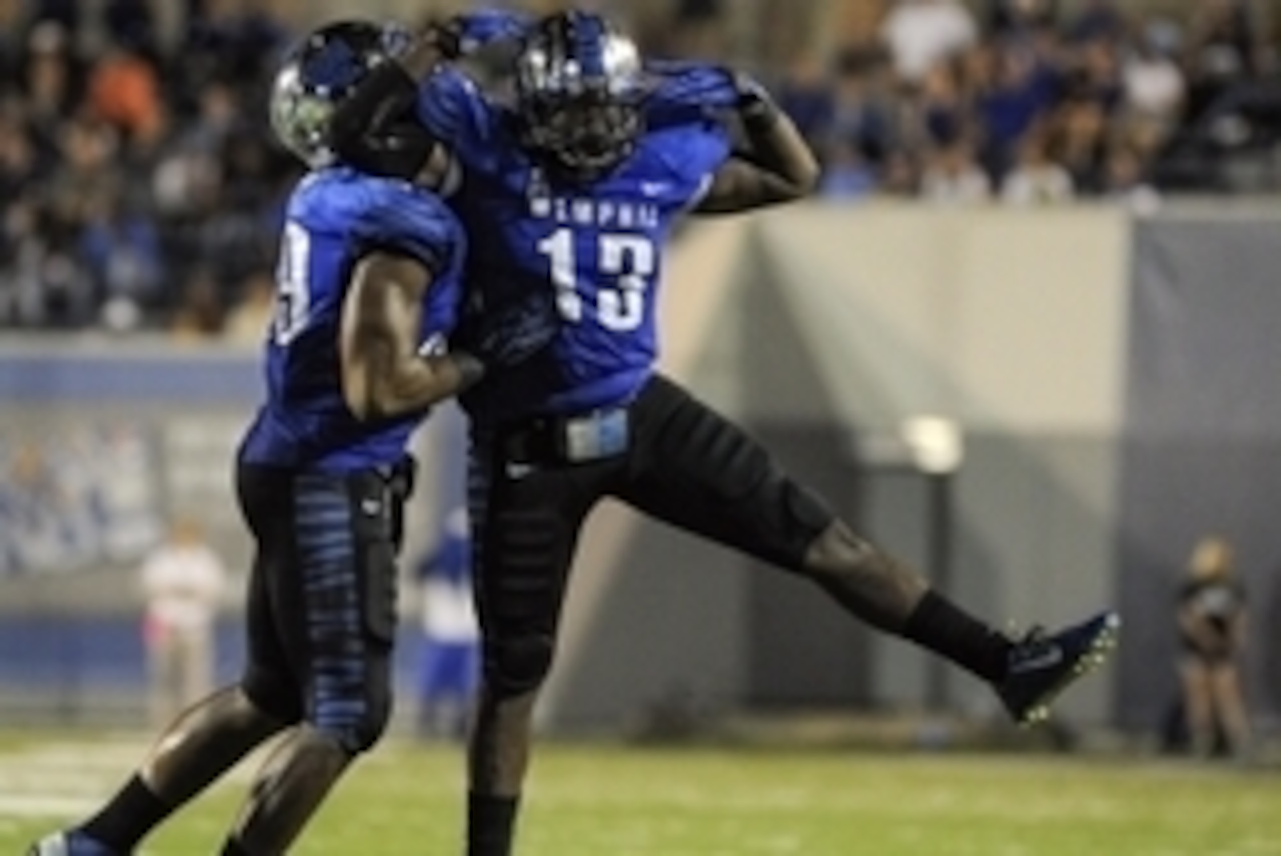 Sep 20, 2014; Memphis, TN, USA; Memphis Tigers linebacker Tank Jakes (13) reacts to intercepting a pass thrown by Middle Tennessee Blue Raiders quarterback Austin Grammer (2) during the game at Liberty Bowl Memorial Stadium. Memphis Tigers beat the Middle