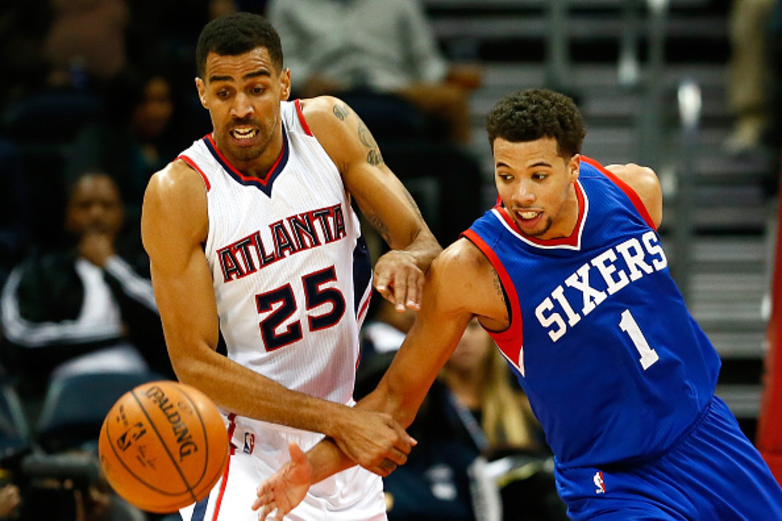 ATLANTA, GA - DECEMBER 10:  Thabo Sefolosha #25 of the Atlanta Hawks and Michael Carter-Williams #1 of the Philadelphia 76ers battle for a loose ball at Philips Arena on December 10, 2014 in Atlanta, Georgia.  NOTE TO USER: User expressly acknowledges and