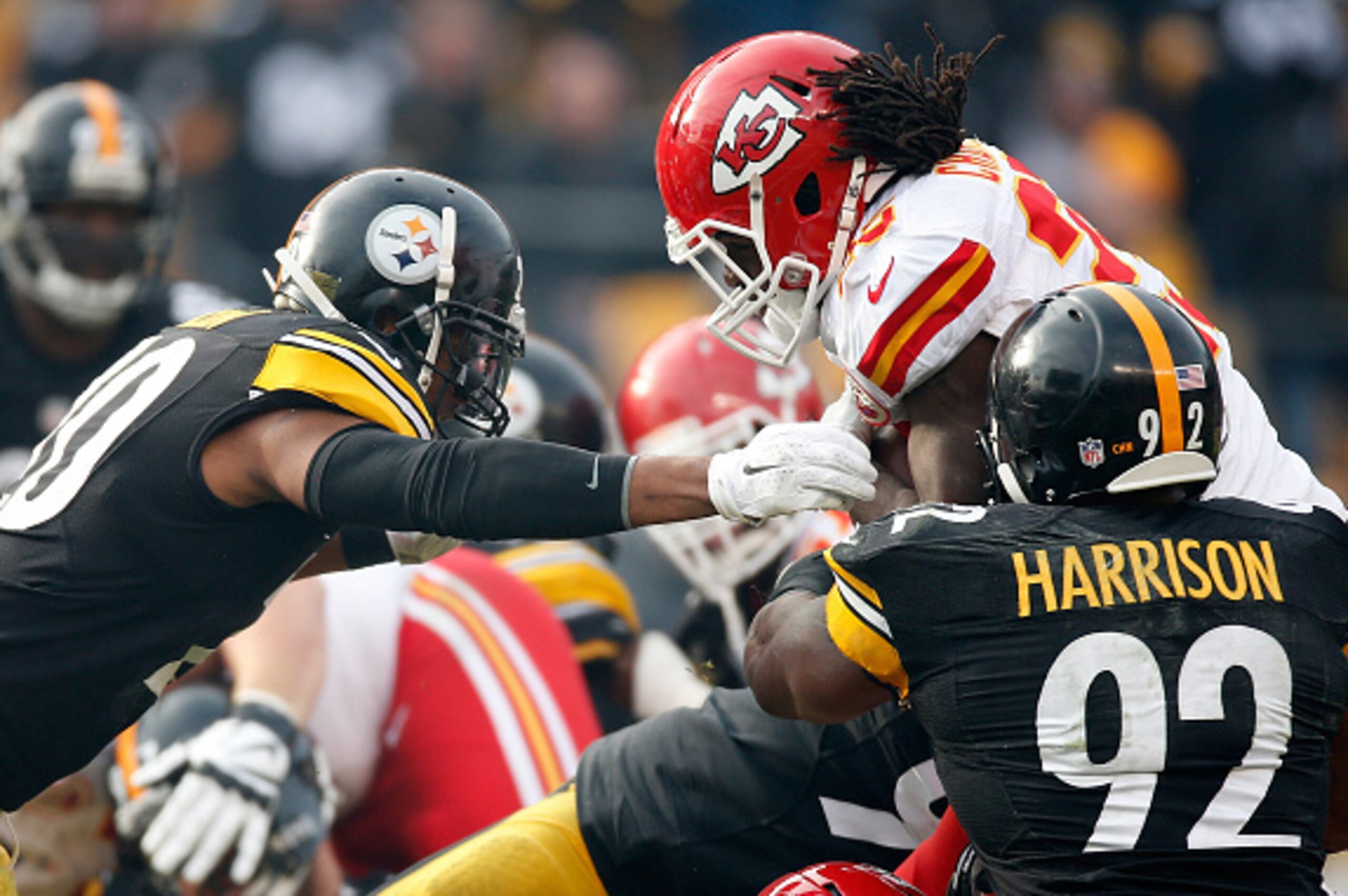 PITTSBURGH, PA - DECEMBER 21:  Jamaal Charles #25 of the Kansas City Chiefs is stopped on fourth down by Ryan Shazier #50 and James Harrison #92 of the Pittsburgh Steelers during the second quarter at Heinz Field on December 21, 2014 in Pittsburgh, Pennsy
