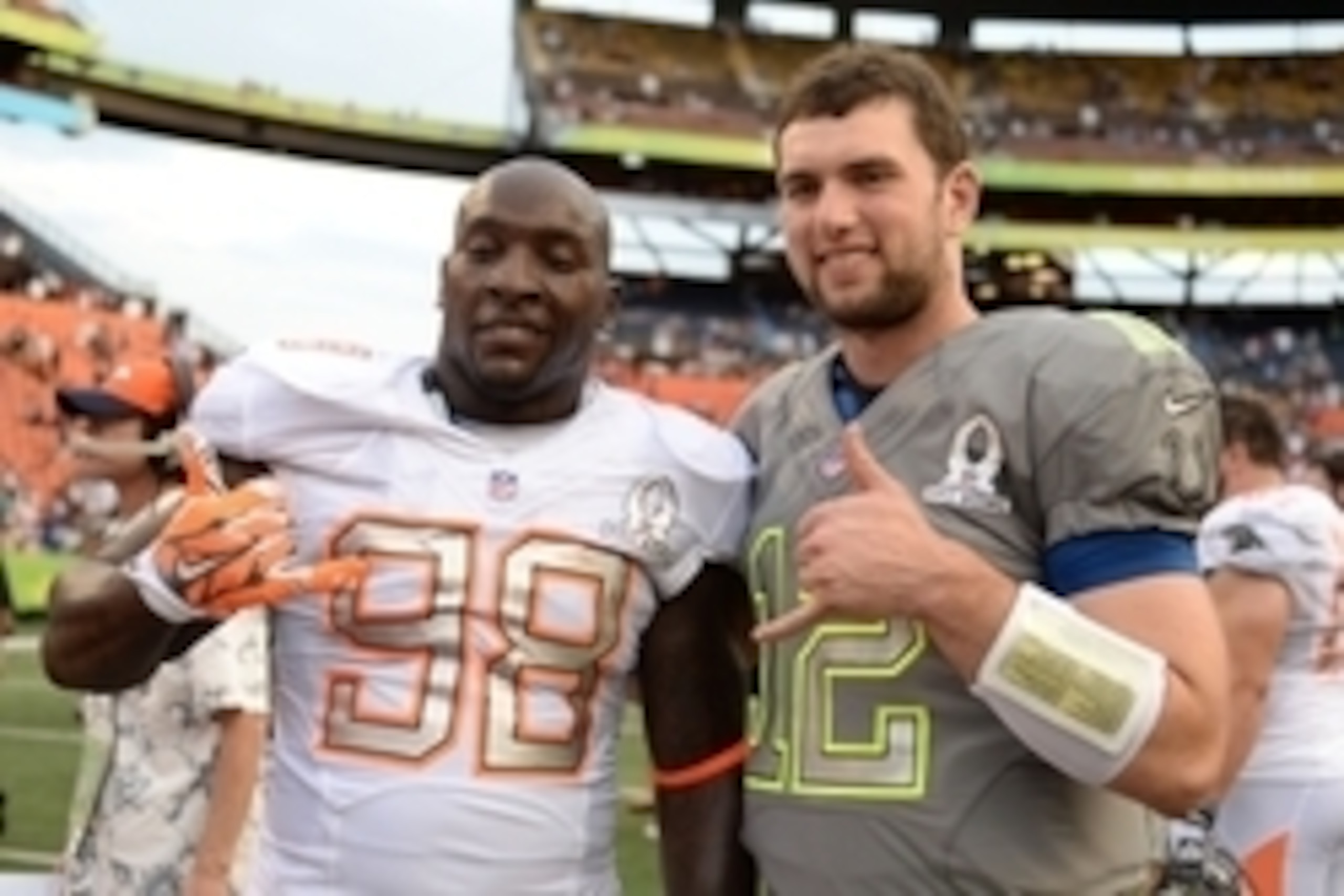 January 26, 2014; Honolulu, HI, USA; Team Rice linebacker Robert Mathis of the Indianapolis Colts (98) poses for a photo with Team Sanders quarterback Andrew Luck of the Indianapolis Colts (12) after the 2014 Pro Bowl at Aloha Stadium. Team Rice defeated 