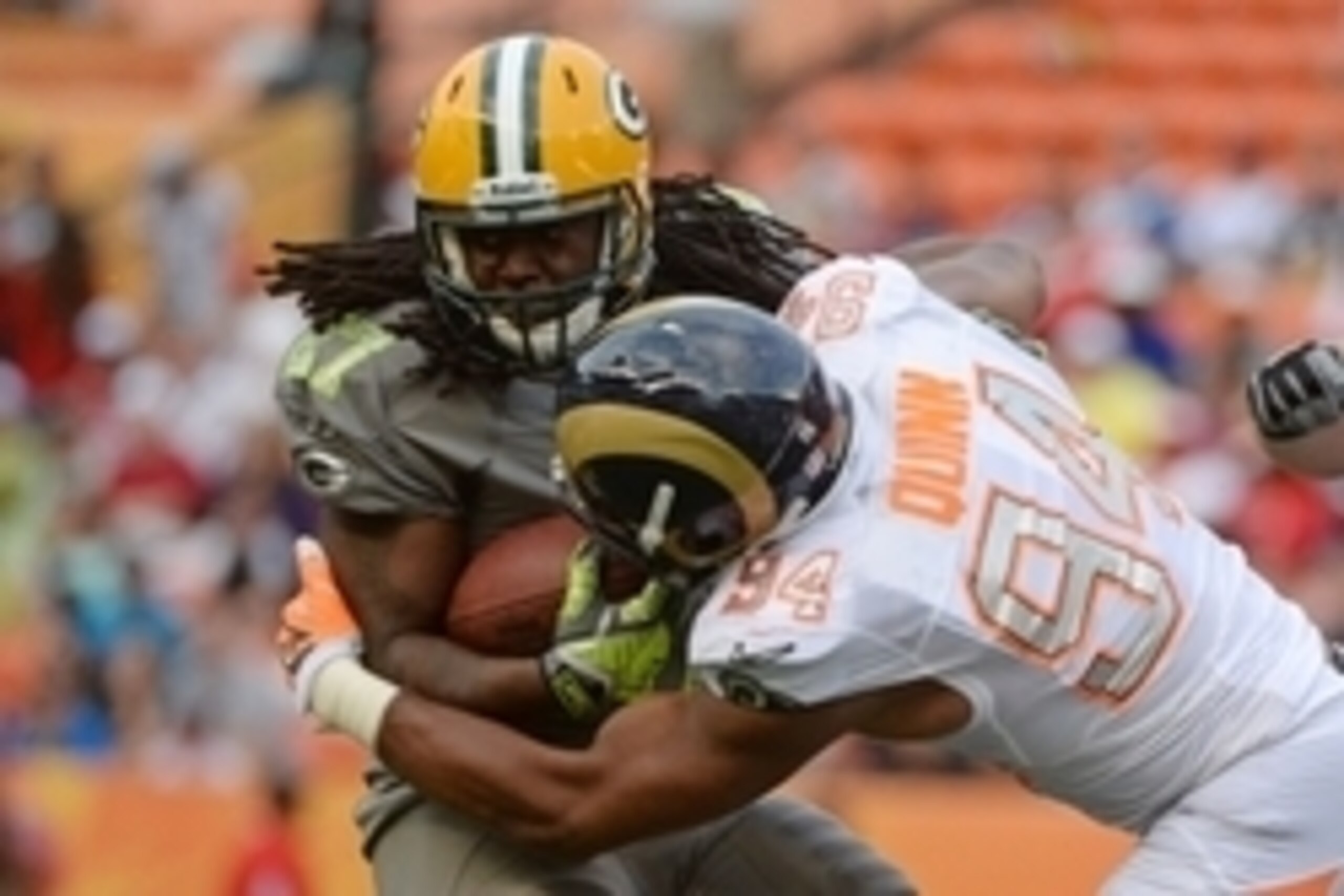 January 26, 2014; Honolulu, HI, USA; Team Sanders running back Eddie Lacy of the Green Bay Packers (27) is tackled by Team Rice defensive end Robert Quinn of the St. Louis Rams (94) during the fourth quarter of the 2014 Pro Bowl at Aloha Stadium. Team Ric
