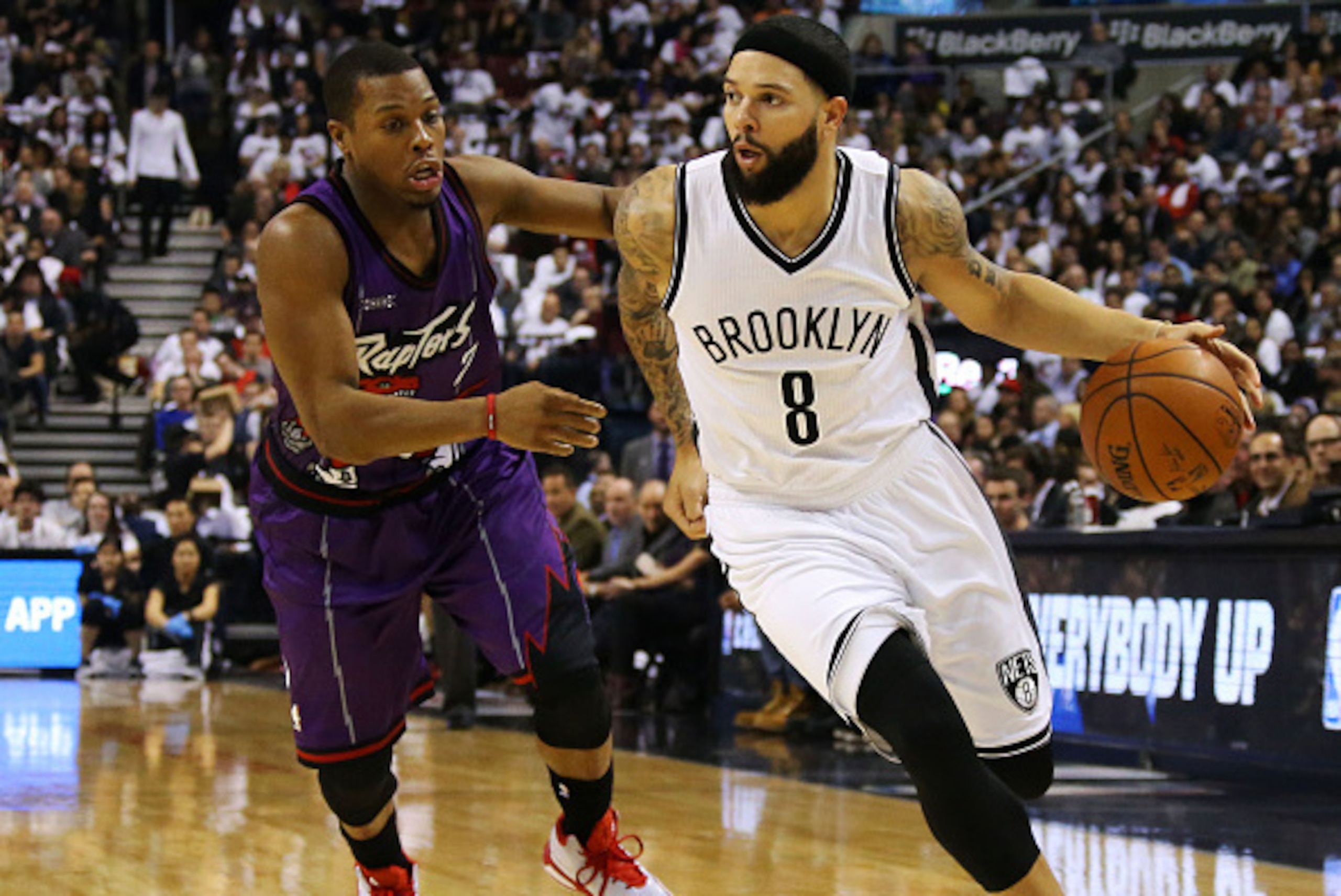 TORONTO,ON - DECEMBER 17:  Deron Williams #8 of the Brooklyn Nets drives to the basket as Kyle Lowry #7 of the Toronto Raptors defends during their NBA game at the Air Canada Centre on December 17, 2014 in Toronto, Ontario, Canada. NOTE TO USER: User expr