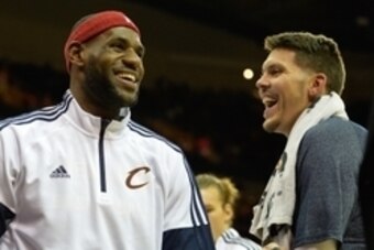 Oct 14, 2014; Cleveland, OH, USA; Cleveland Cavaliers forward LeBron James (left) reacts with forward Mike Miller (18) during a timeout against the Milwaukee Bucks at Quicken Loans Arena. Cleveland won 106-100. Mandatory Credit: David Richard-USA TODAY Sp