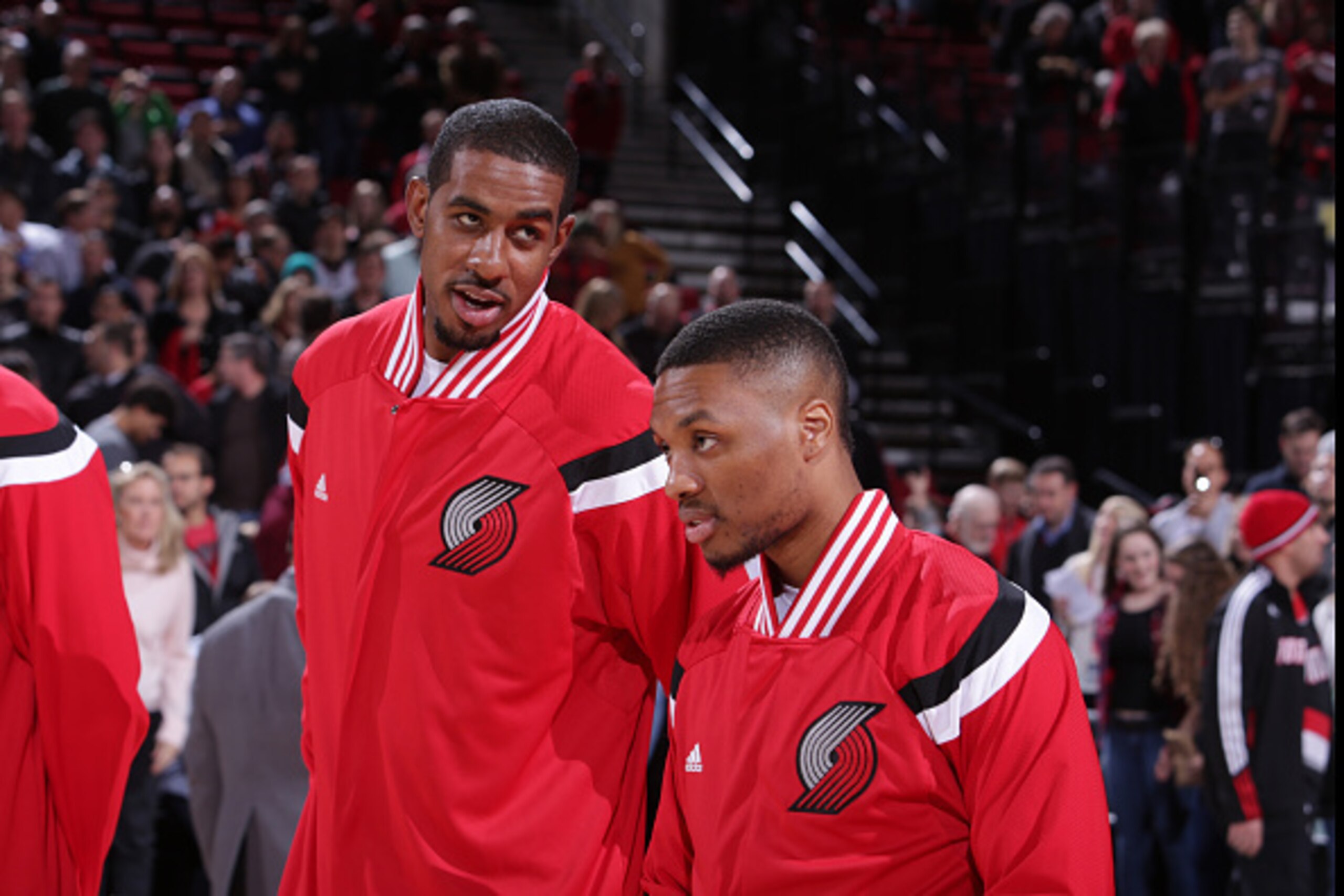PORTLAND, OR - DECEMBER 4: LaMarcus Aldridge #12 and Damian Lillard #0 of the Portland Trail Blazers stand for the national anthem before a game against the Indiana Pacers on December 4, 2014 at the Moda Center Arena in Portland, Oregon. NOTE TO USER: Use
