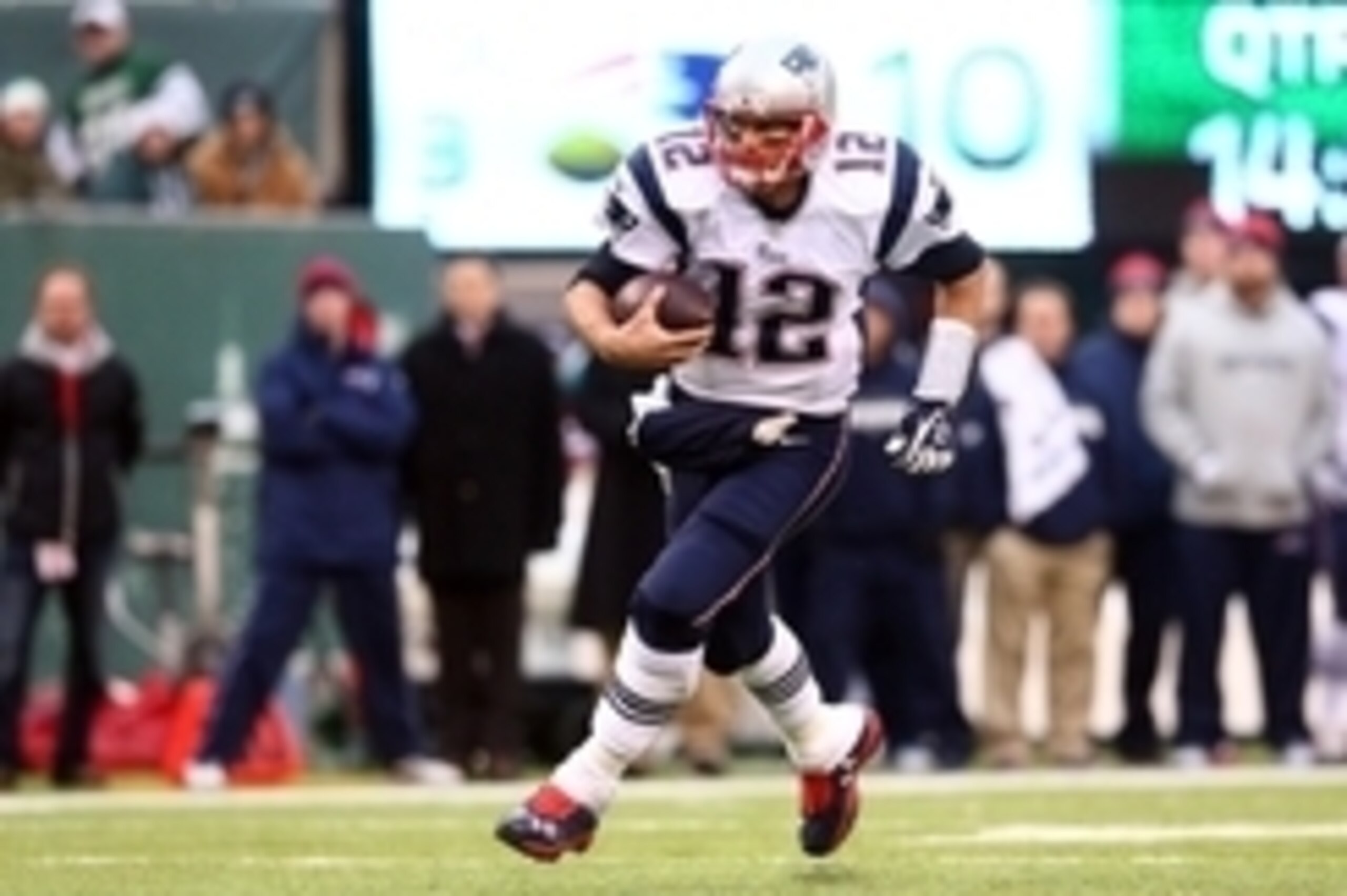 Dec 21, 2014; East Rutherford, NJ, USA; New England Patriots quarterback Tom Brady (12) runs the ball against the New York Jets during the fourth quarter at MetLife Stadium. The Patriots defeated the Jets 17-16. Mandatory Credit: Brad Penner-USA TODAY Spo
