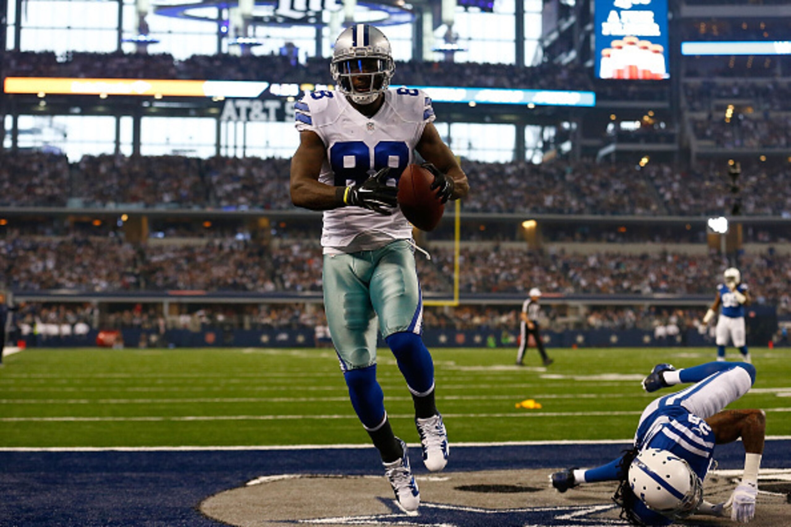 ARLINGTON, TX - DECEMBER 21:  Dez Bryant #88 of the Dallas Cowboys makes a touchdown reception as Greg Toler #28 of the Indianapolis Colts defends in the first half at AT&T Stadium on December 21, 2014 in Arlington, Texas.  (Photo by Tom Pennington/Getty 