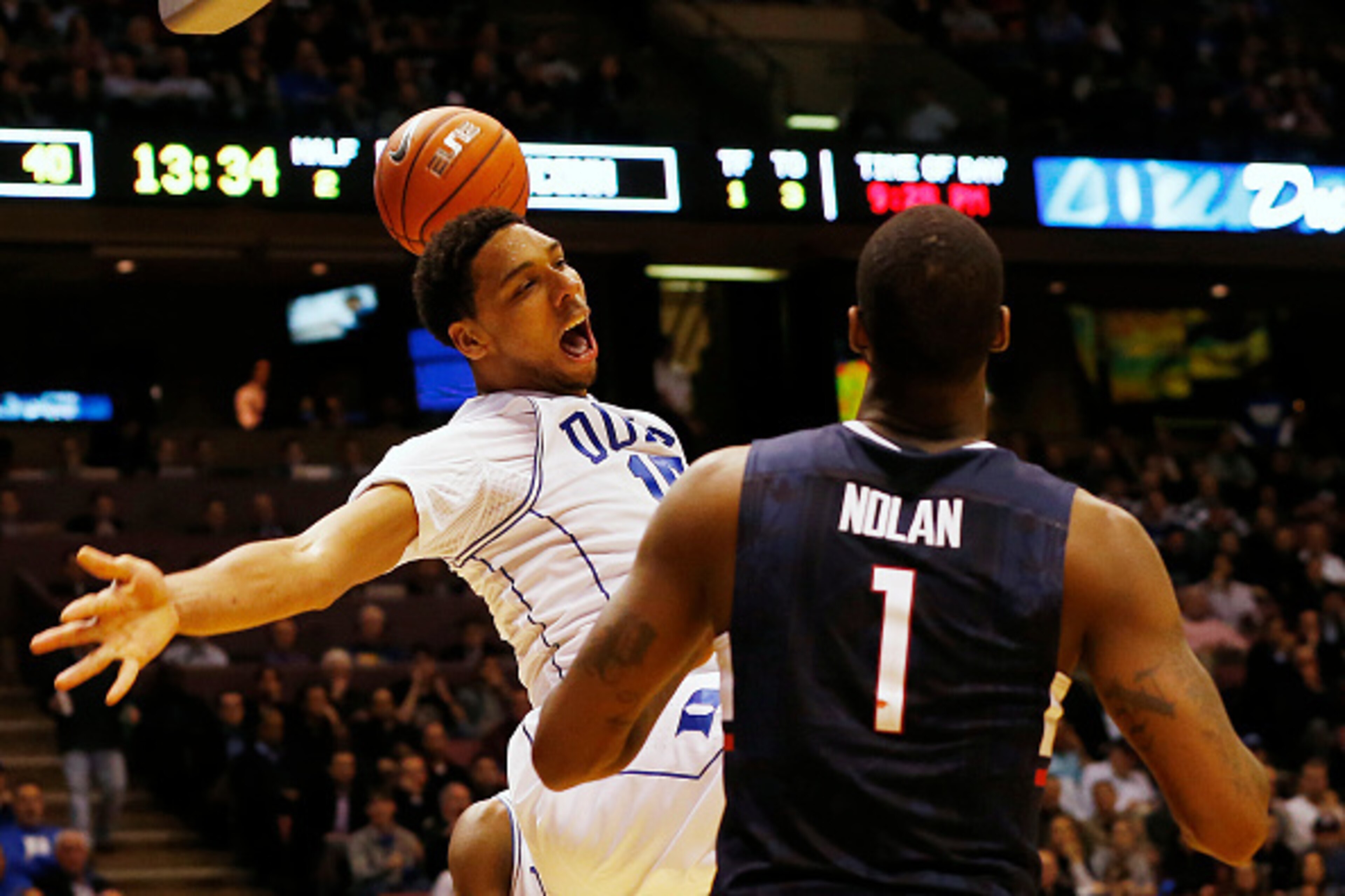 EAST RUTHERFORD, NJ - DECEMBER 18: Jahlil Okafor #15 of the Duke Blue Devils reacts after a dunk as Phillip Nolan #1 of the Connecticut Huskies looks on during the second half of an NCAA college basketball game on December 18, 2014 at the Izod Center in E