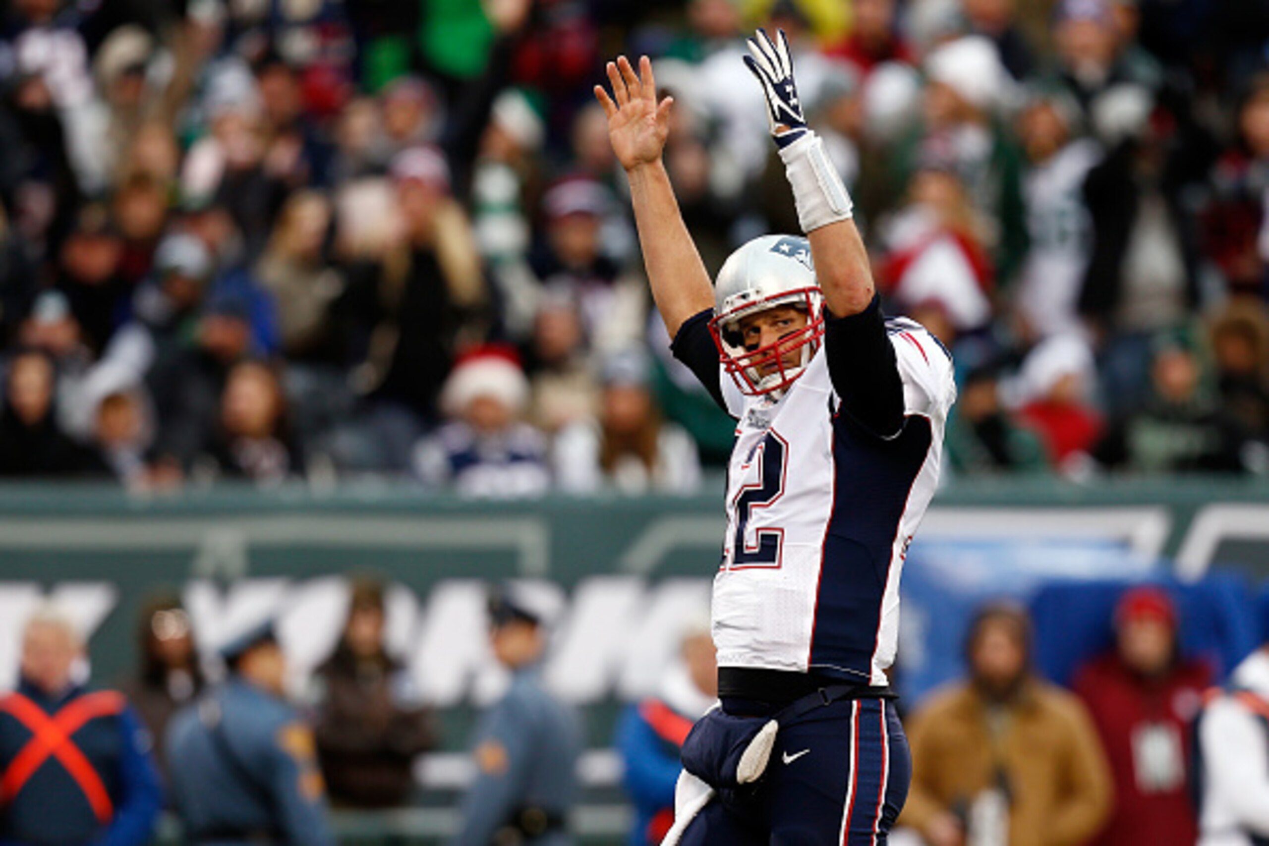 EAST RUTHERFORD, NJ - DECEMBER 21:  Quarterback Tom Brady #12 of the New England Patriots celebrates a fourth quarter touchdown against the New York Jets during a game at MetLife Stadium on December 21, 2014 in East Rutherford, New Jersey.  (Photo by Jeff