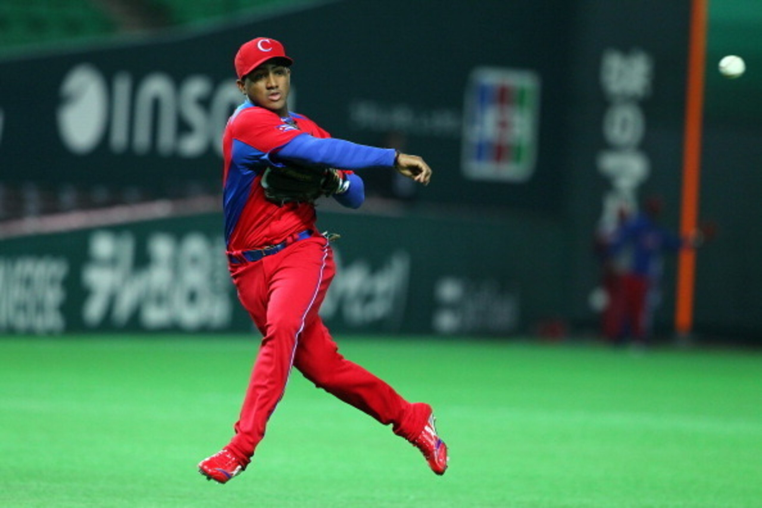 FUKUOKA, JAPAN - MARCH 01: Infielder Andy Ibanez #12 of Cuba throws the ball during the friendly game between Fukuoka Softbank Hawks and Cuba at Fukuoka Yafuoku! Dome on March 1, 2013 in Fukuoka, Japan. (Photo by Koji Watanabe/Getty Images)