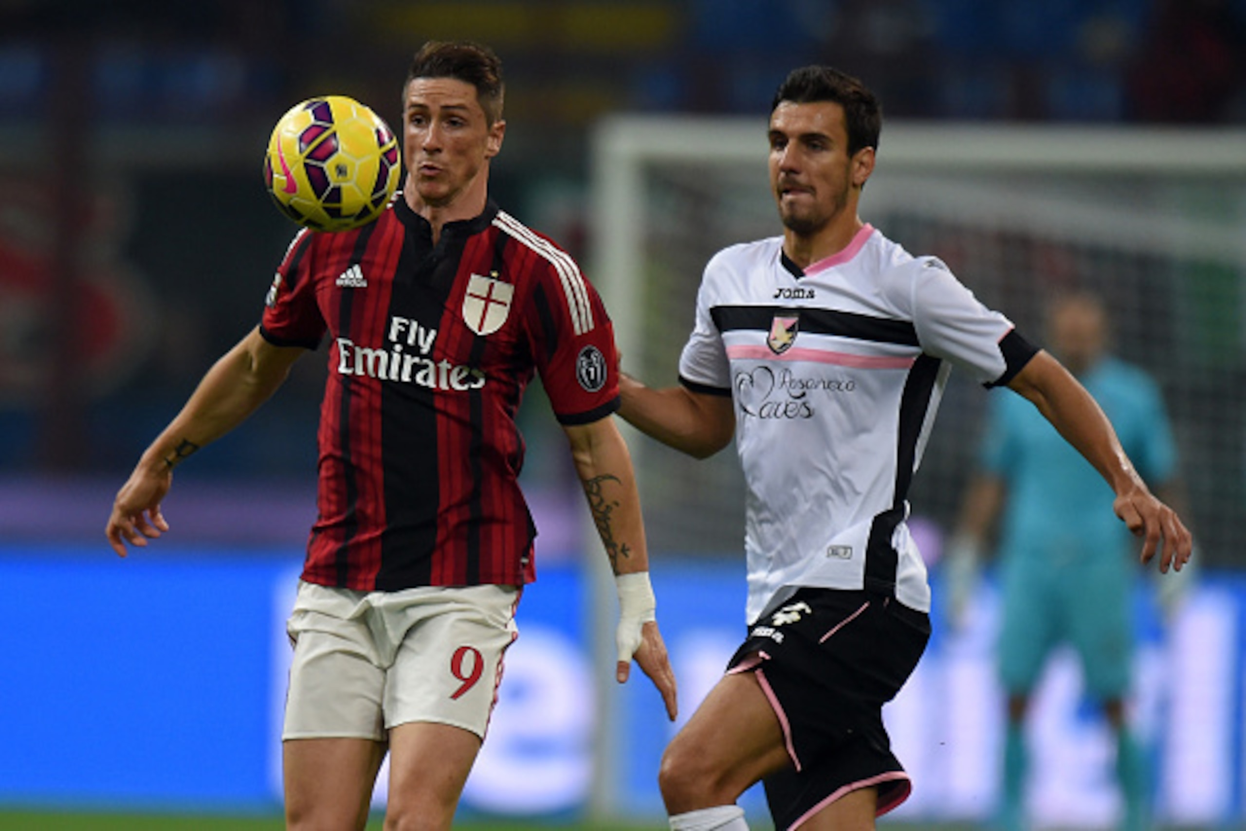 MILAN, ITALY - NOVEMBER 02: Fernando Torres (L) of Milan controls the ball as Sinisa Andelkovic of Palermo tackles during the Serie A match between AC Milan and US Citta di Palermo at Stadio Giuseppe Meazza on November 2, 2014 in Milan, Italy.  (Photo by 