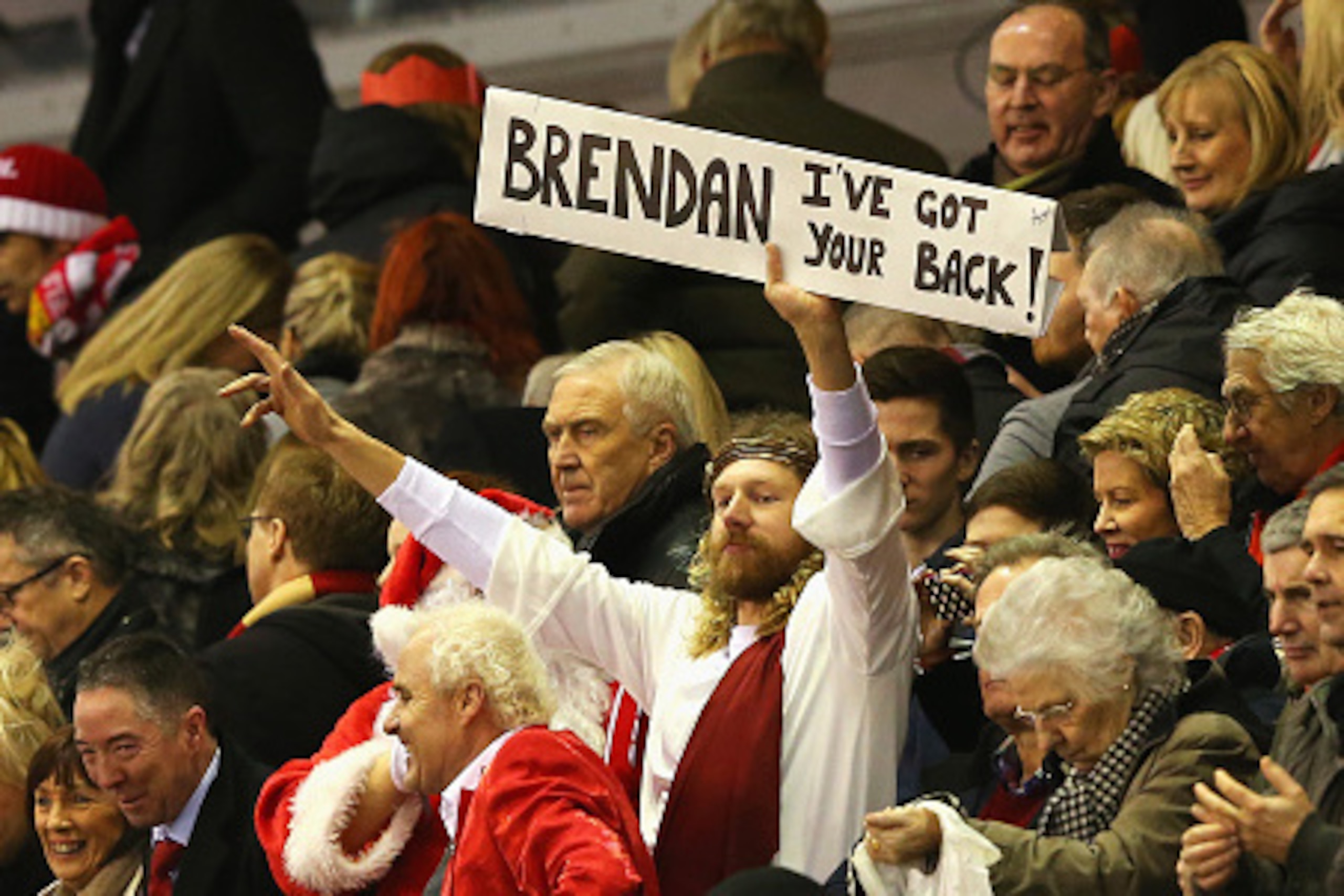 LIVERPOOL, ENGLAND - DECEMBER 21: Fans dressed as Father Christmas and Jesus display a sign for Brendan Rodgers, manager of Liverpool during the Barclays Premier League match between Liverpool and Arsenal at Anfield on December 21, 2014 in Liverpool, Eng LIVERPOOL, ENGLAND - DECEMBER 21: Fans dressed as Father Christmas and Jesus display a sign for Brendan Rodgers, manager of Liverpool during the Barclays Premier League match between Liverpool and Arsenal at Anfield on December 21, 2014 in Liverpool, Eng