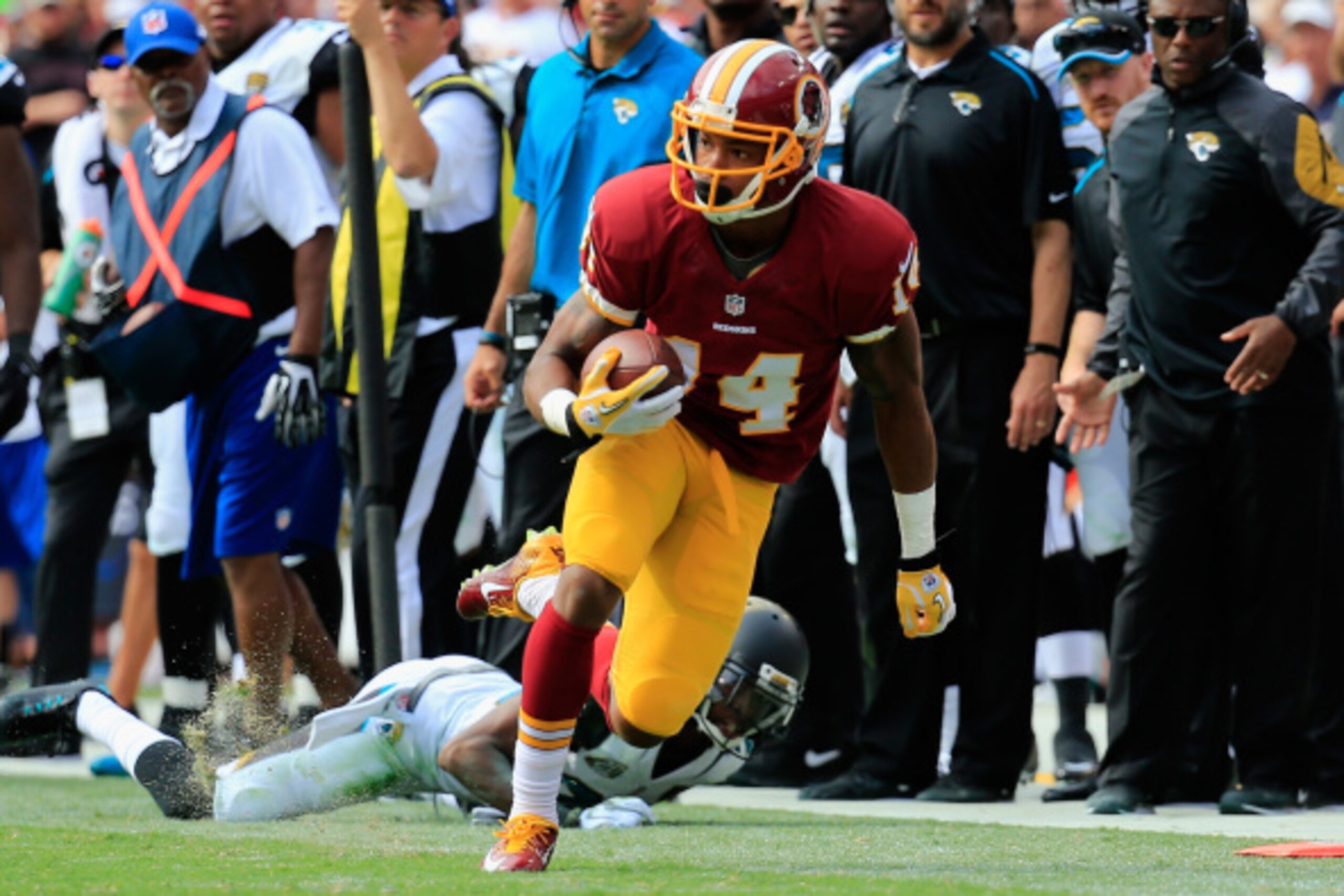 LANDOVER, MD - SEPTEMBER 14:  Wide receiver Ryan Grant #14 of the Washington Redskins makes a catch over cornerback Alan Ball #23 of the Jacksonville Jaguars during the second half at FedExField on September 14, 2014 in Landover, Maryland.  (Photo by Rob 
