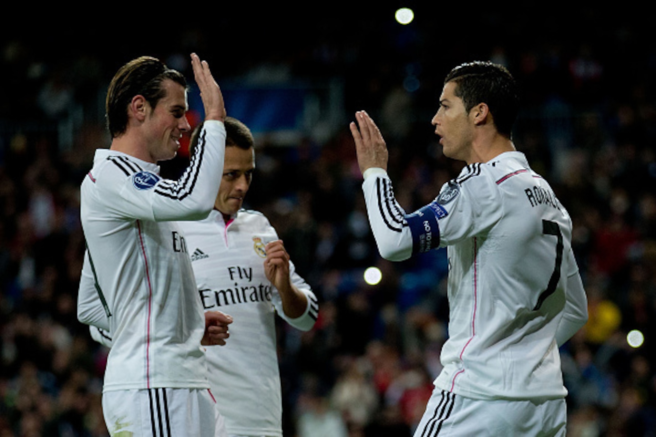 MADRID, SPAIN - DECEMBER 09:  Cristiano Ronaldo (R) of Real Madrid CF celebrates scoring their opening goal with teammates Gareth Bale (L) and Javier Hernandez Chicharito (2ndL) during the UEFA Champions League Group B match between Real Madrid CF and PFC
