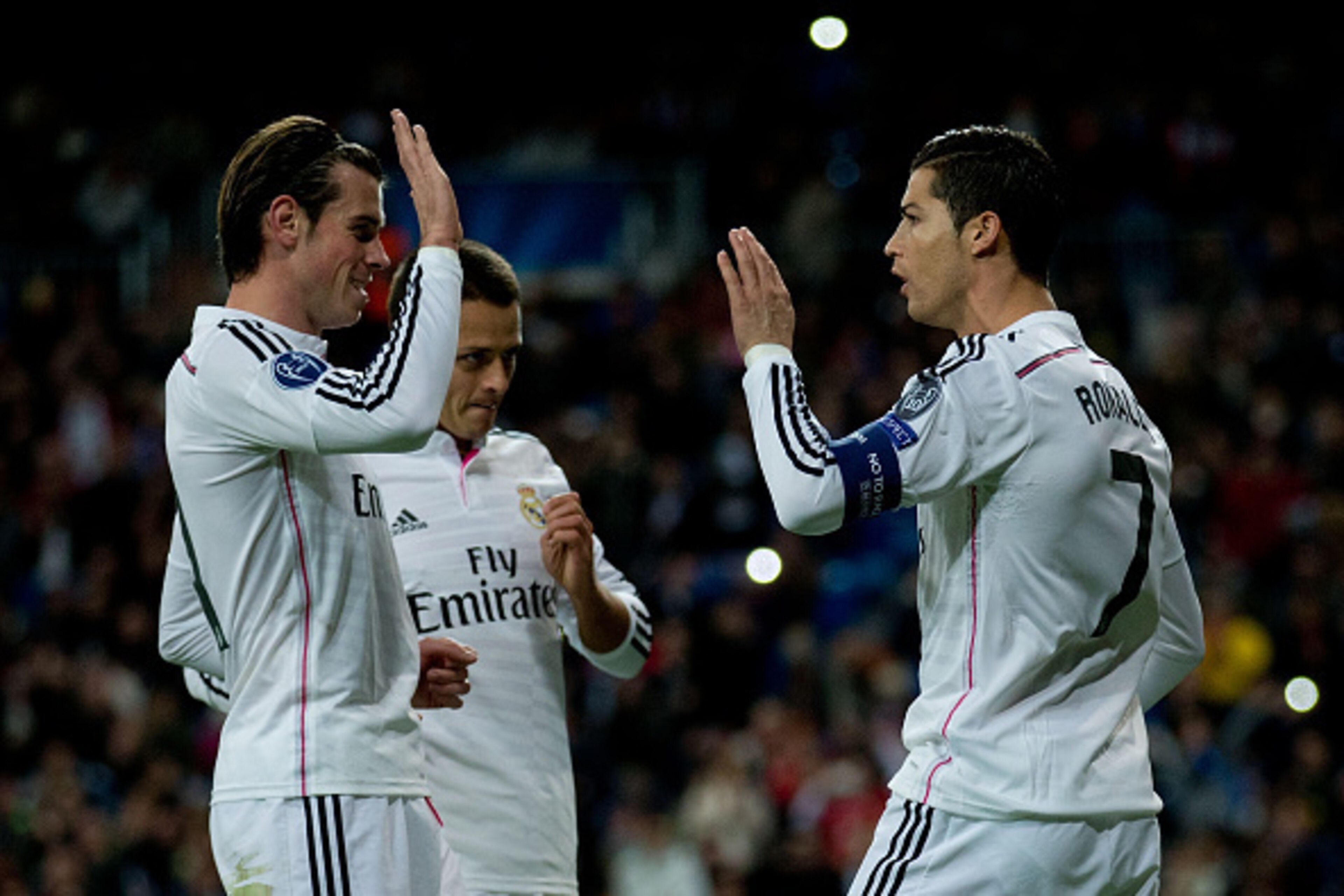 MADRID, SPAIN - DECEMBER 09: Cristiano Ronaldo (R) of Real Madrid CF celebrates scoring their opening goal with teammates Gareth Bale (L) and Javier Hernandez Chicharito (2ndL) during the UEFA Champions League Group B match between Real Madrid CF and PFC MADRID, SPAIN - DECEMBER 09: Cristiano Ronaldo (R) of Real Madrid CF celebrates scoring their opening goal with teammates Gareth Bale (L) and Javier Hernandez Chicharito (2ndL) during the UEFA Champions League Group B match between Real Madrid CF and PFC