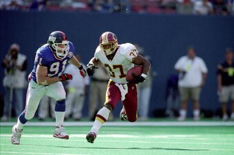 19 Sep 1999:  Larry Centers #37 of the Washington Redskins runs with the ball as Ryan Phillips #91 of the New York Giants runs after him down during a game at the Giants Stadium in East Rutherford, New Jersey. The Redskins defeated the Giants 50-21. Manda