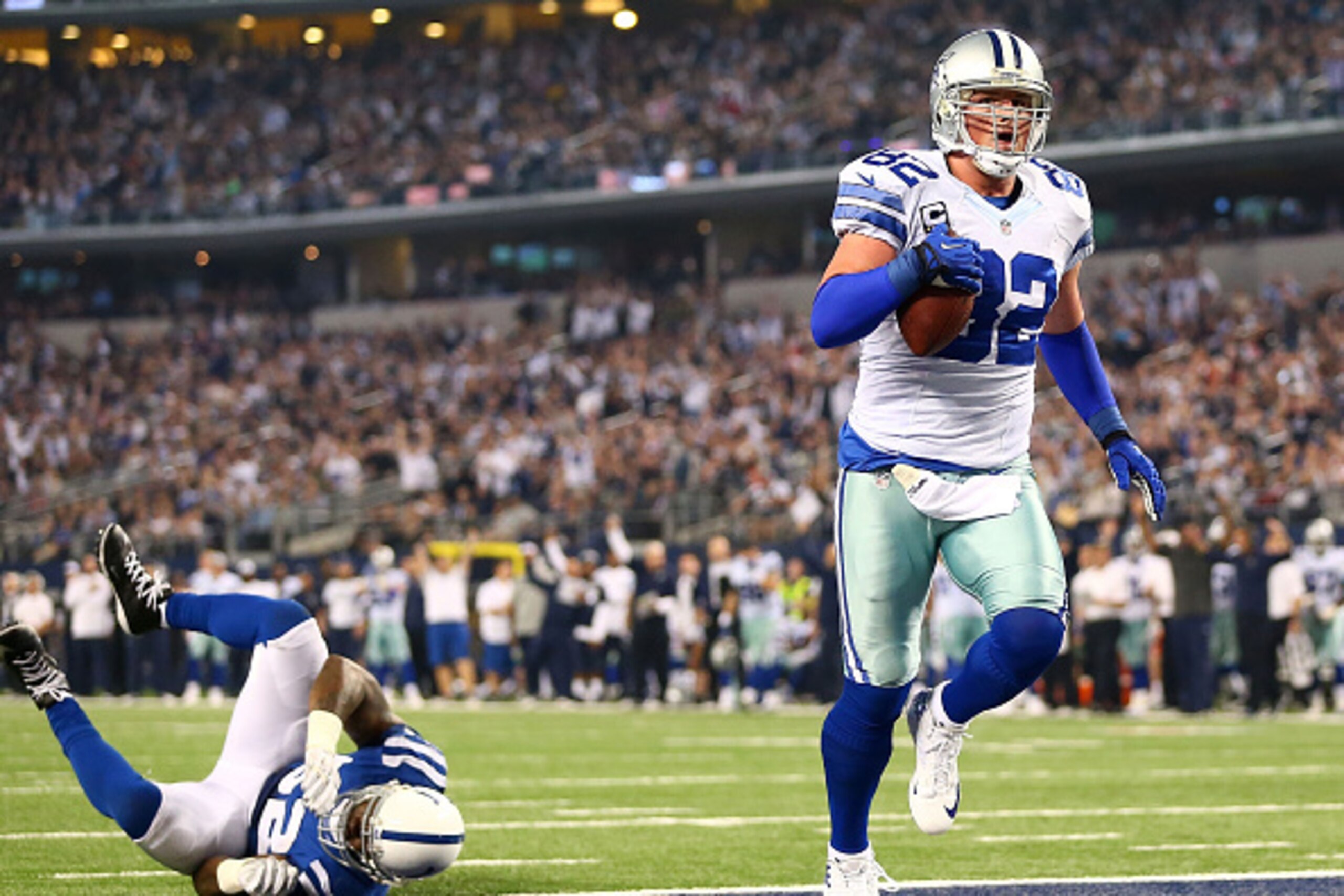 ARLINGTON, TX - DECEMBER 21:  D'Qwell Jackson #52 of the Indianapolis Colts rolls on the turf as Jason Witten #82 of the Dallas Cowboys scores a touchdown in the second half at AT&T Stadium on December 21, 2014 in Arlington, Texas.  (Photo by Ronald Marti