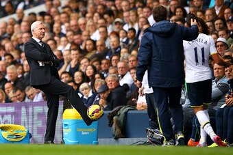 LONDON, ENGLAND - OCTOBER 26:  Alan Pardew manager of Newcastle United controls a ball as Erik Lamela of Spurs speaks with Fabricio Coloccini of Newcastle United next to Mauricio Pochettino, manager of Spurs during the Barclays Premier League match betwee