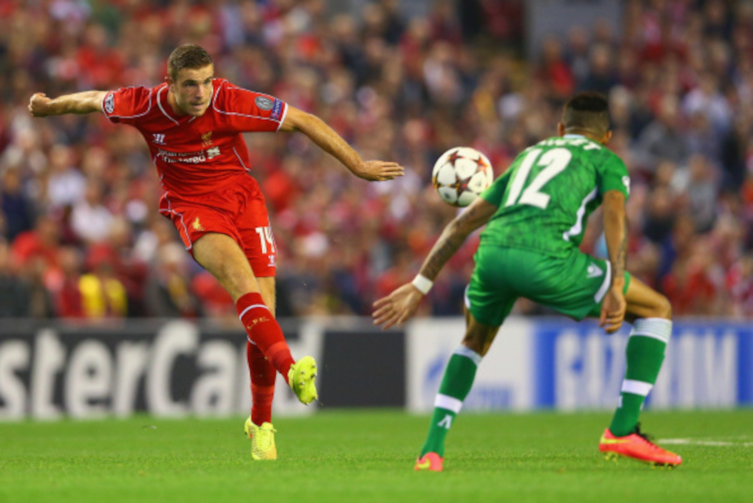 LIVERPOOL, ENGLAND - SEPTEMBER 16: Jordan Henderson of Liverpool shoots past Anicet Abel of PFC Ludogorets Razgrad during the UEFA Champions League Group B match between Liverpool FC and PFC Ludogorets Razgrad at Anfield on September 16, 2014 in Liverpoo LIVERPOOL, ENGLAND - SEPTEMBER 16: Jordan Henderson of Liverpool shoots past Anicet Abel of PFC Ludogorets Razgrad during the UEFA Champions League Group B match between Liverpool FC and PFC Ludogorets Razgrad at Anfield on September 16, 2014 in Liverpoo