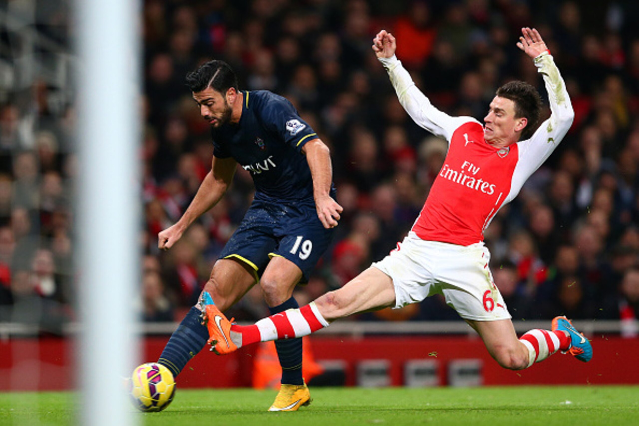 LONDON, ENGLAND - DECEMBER 03:  Laurent Koscielny of Arsenal attempts to block Graziano Pelle of Southampton during the Barclays Premier League match between Arsenal and Southampton at Emirates Stadium on December 3, 2014 in London, England.  (Photo by Mi