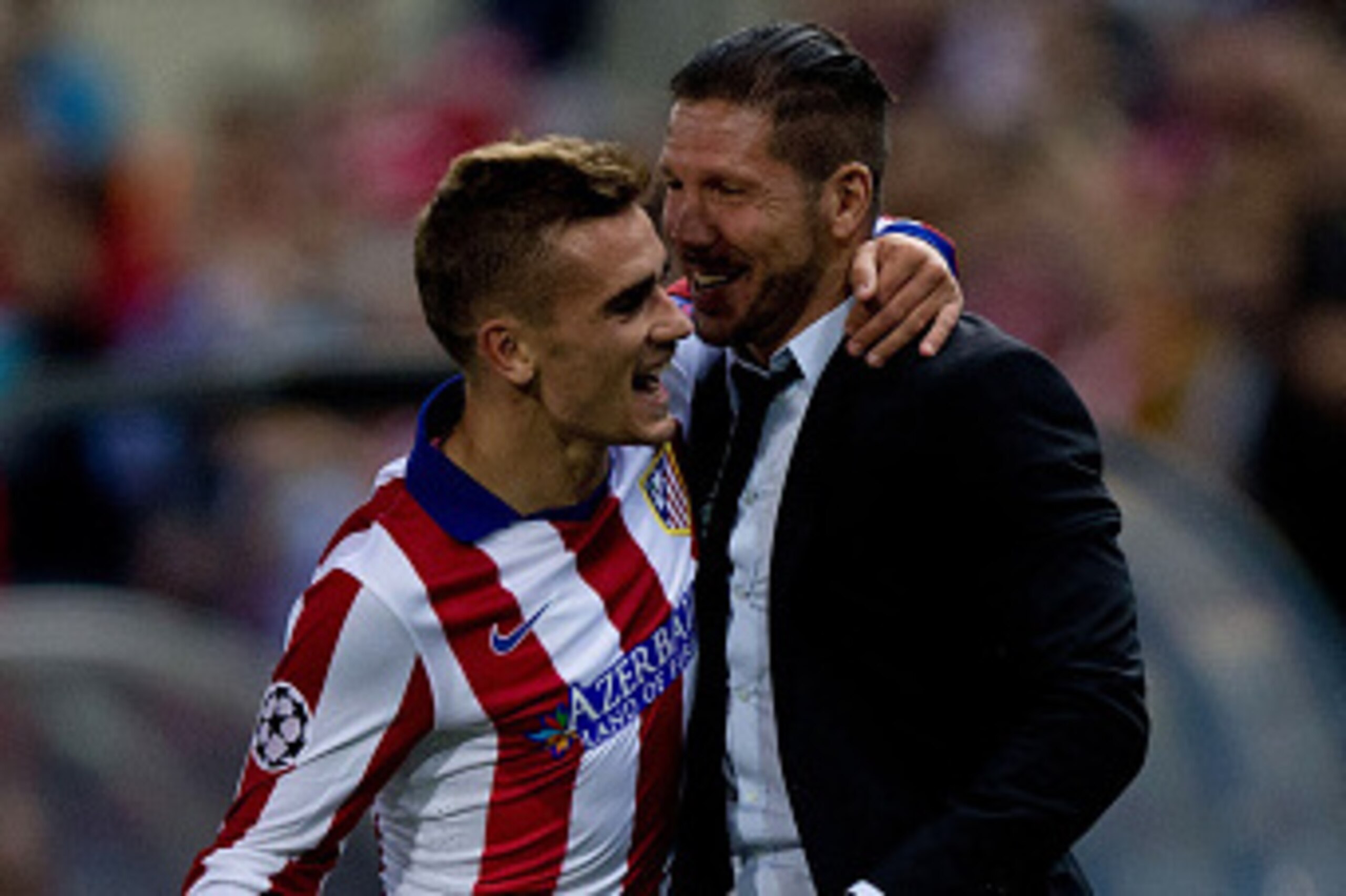 MADRID, SPAIN - OCTOBER 22:  Antoine Griezmann (L) of Atletico de Madrid embraces head coach Diego Pablo Simeone (R) to celebrate scoring their third goal during the UEFA Champions League group A match between Club Atletico de Madrid and Malmo FF at Vicen