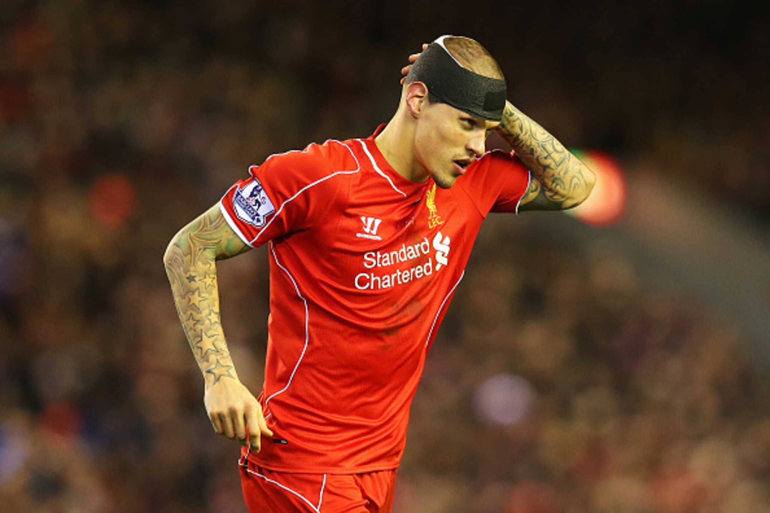 LIVERPOOL, ENGLAND - DECEMBER 21:  Martin Skrtel of Liverpool looks on with his head bandaged during the Barclays Premier League match between Liverpool and Arsenal at Anfield on December 21, 2014 in Liverpool, England.  (Photo by Alex Livesey/Getty Image