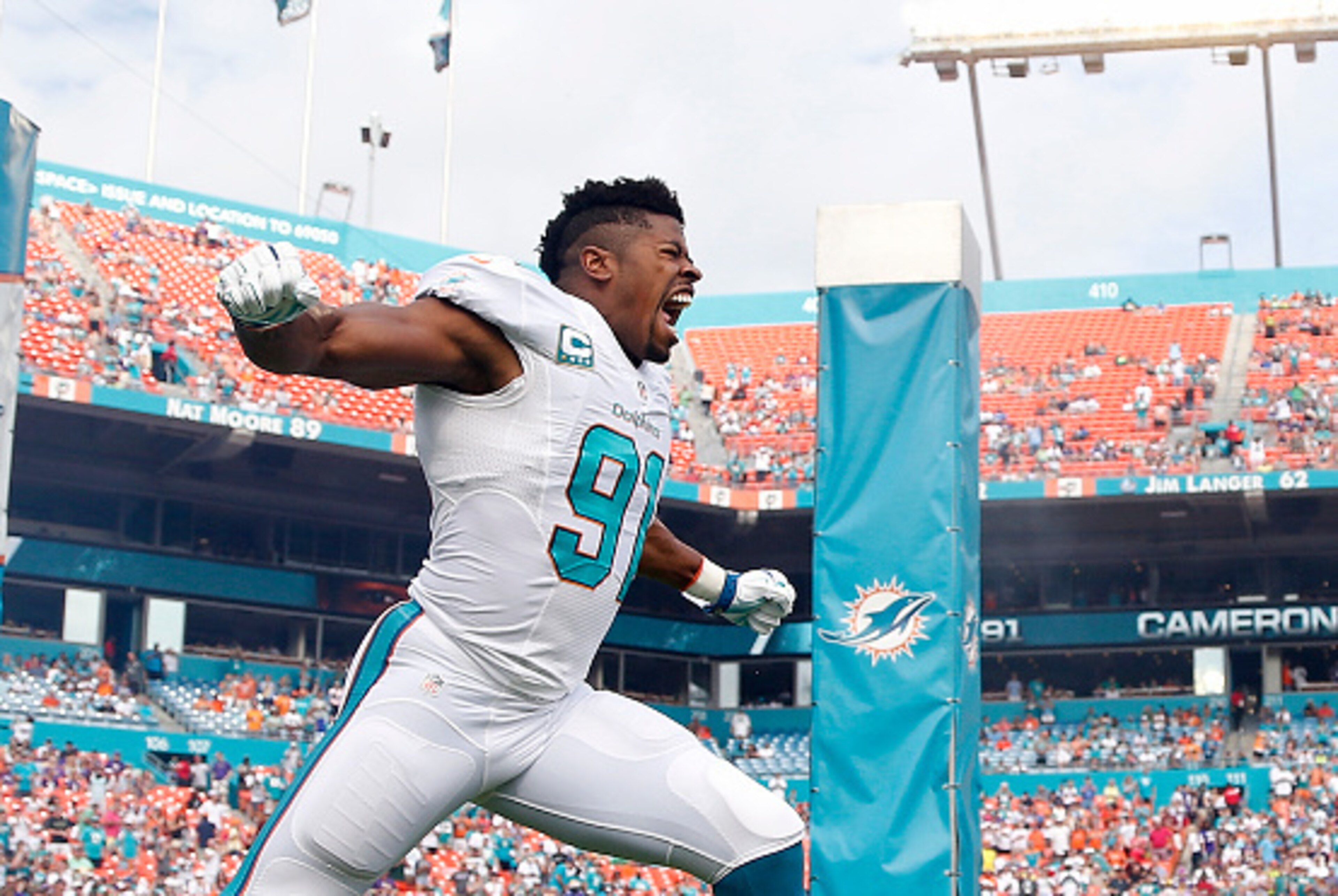 MIAMI GARDENS, FL - DECEMBER 21: Defensive end Cameron Wake #91 of the Miami Dolphins enters the field before the Dolphins met the Minnesota Vikings in a game at Sun Life Stadium on December 21, 2014 in Miami Gardens, Florida. (Photo by Rob Foldy/Getty MIAMI GARDENS, FL - DECEMBER 21: Defensive end Cameron Wake #91 of the Miami Dolphins enters the field before the Dolphins met the Minnesota Vikings in a game at Sun Life Stadium on December 21, 2014 in Miami Gardens, Florida. (Photo by Rob Foldy/Getty