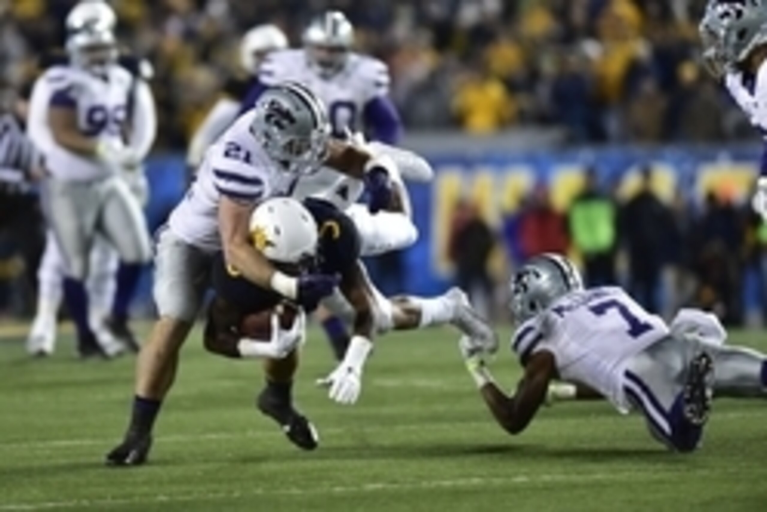 Nov 20, 2014; Morgantown, WV, USA; West Virginia Mountaineers wide receiver Mario Alford (5) with the ball as Kansas State Wildcats linebacker Jonathan Truman (21) and Kansas State Wildcats defensive back Danzel McDaniel (7) defend in the second quarter a