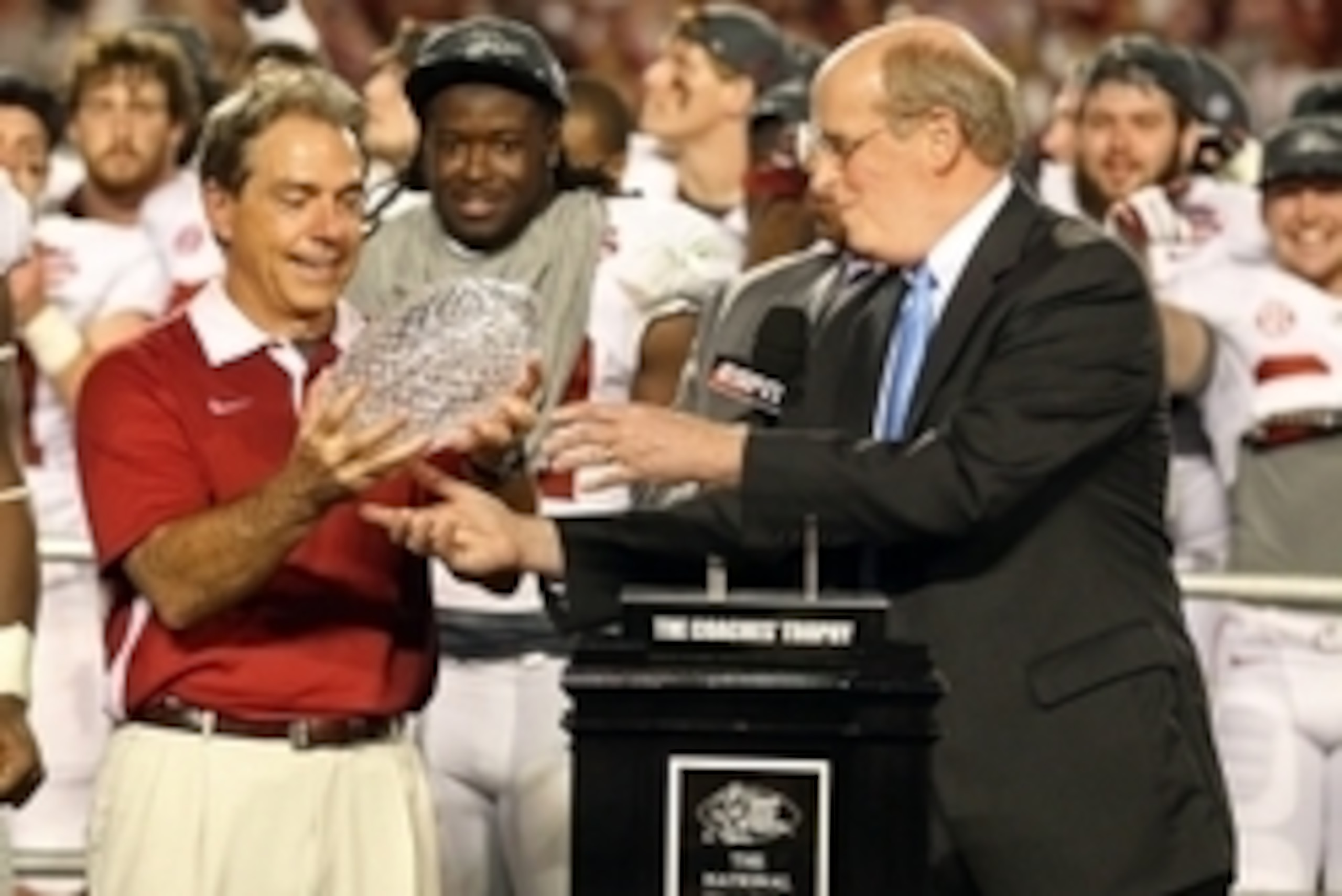 Jan 7, 2013; Miami, FL, USA; BCS chief executive officer Bill Hancock (right) presents Alabama Crimson Tide head coach Nick Saban with the Coaches Trophy after the 2013 BCS Championship game against the Notre Dame Fighting Irish at Sun Life Stadium. Alaba