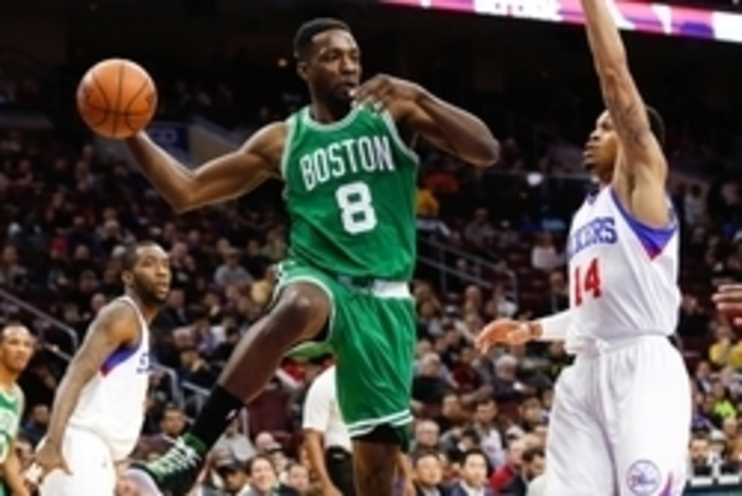 Dec 15, 2014; Philadelphia, PA, USA; Boston Celtics forward Jeff Green (8) passes around the defense of Philadelphia 76ers guard K.J. McDaniels (14) during the first quarter at Wells Fargo Center. Mandatory Credit: Bill Streicher-USA TODAY Sports