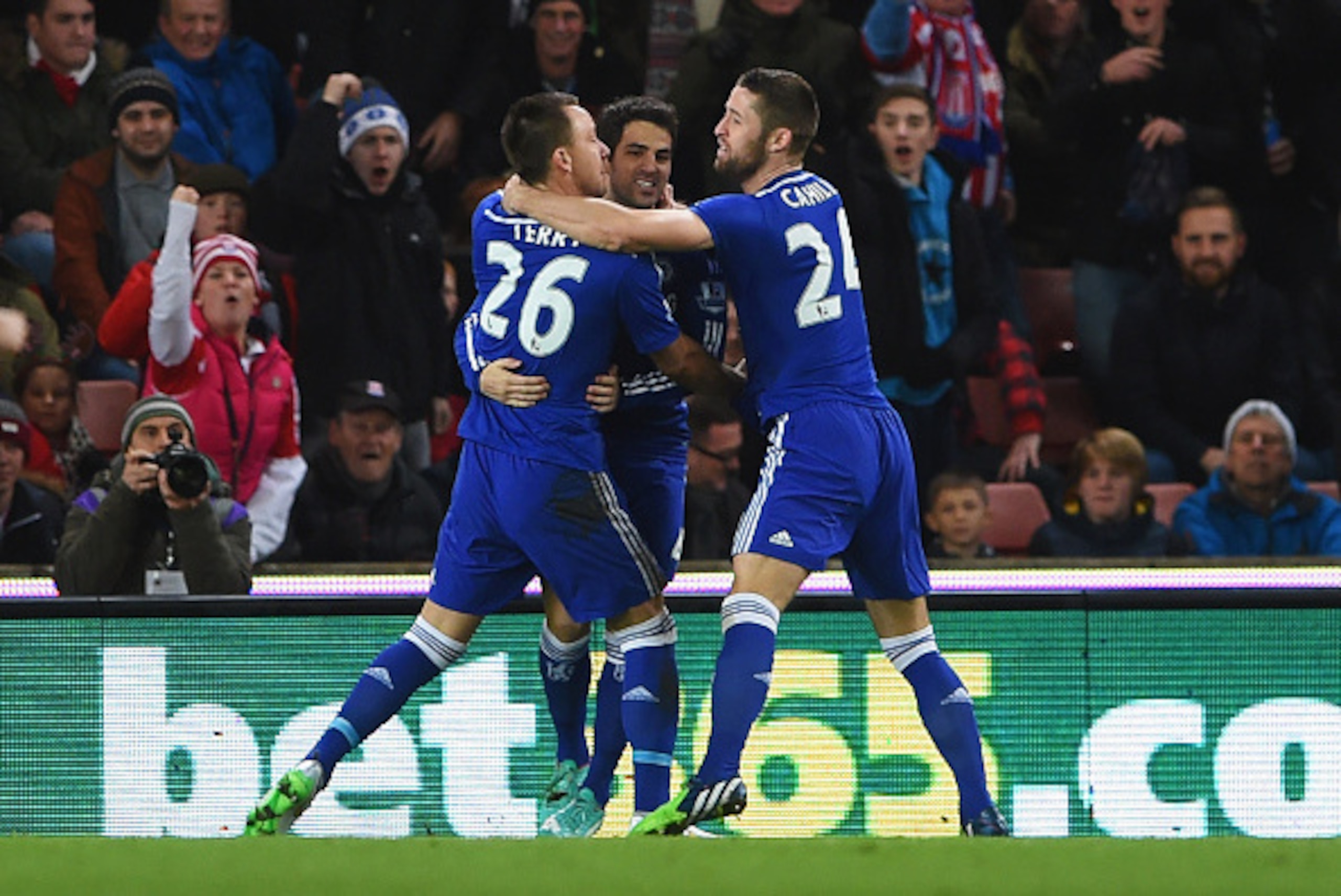 STOKE ON TRENT, ENGLAND - DECEMBER 22:  John Terry of Chelsea (26) celebrates with Cesc Fabregas (C) and Gary Cahill (R) as he scores their first goal during the Barclays Premier League match between Stoke City and Chelsea at Britannia Stadium on December