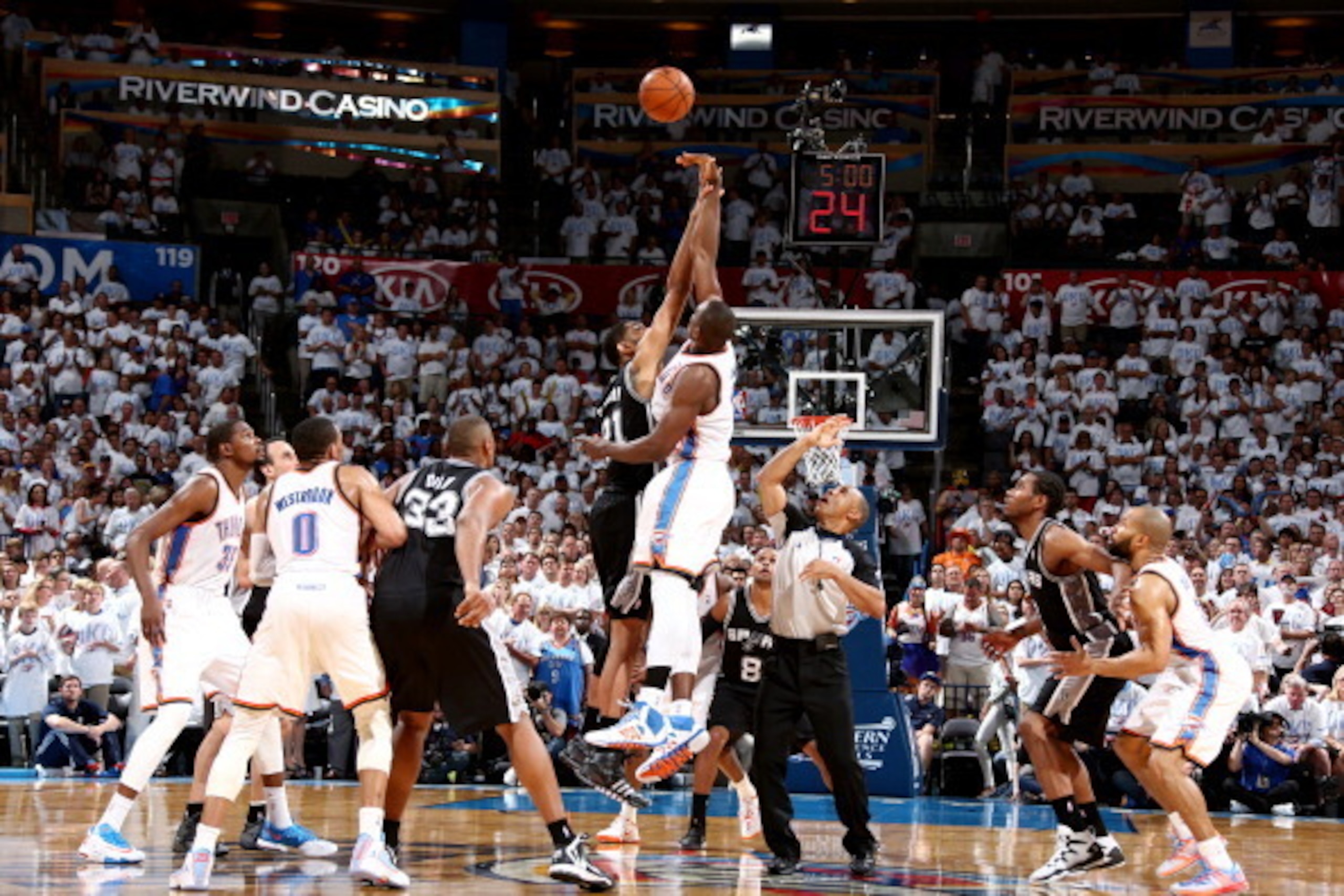 OKLAHOMA CITY, OK - May 31:  Serge Ibaka #9 of the Oklahoma City Thunder jumps for the tip off against Tim Duncan #21 of the San Antonio Spurs in Game 6 of the Western Conference Finals during the 2014 NBA Playoffs at the Chesapeake Arena on May 31, 2014 